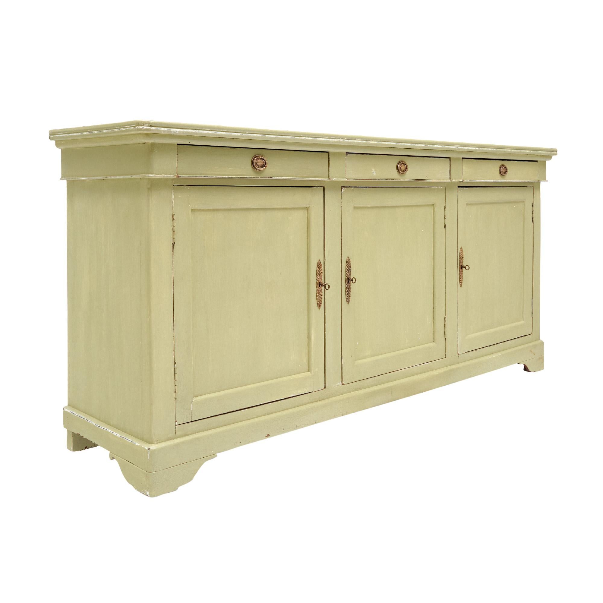 French Buffet, enfilade from the Rhone Valley, of solid oak. The piece was crafted right after the Louis Philippe era. This important enfilade features three dovetailed drawers and three doors opening to ample storage. It boasts a patinated