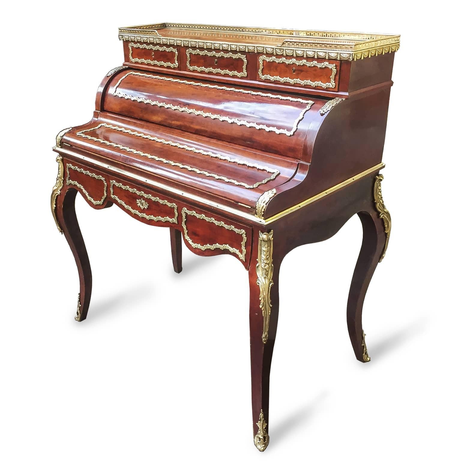 A late 19th century Napoleon III bronze-mounted mahogany bureau à cylinder, an elegant French Bureau de Dame or Bonheur du Jour, a ladies writing desk with cartonnier which opens up by sliding the central drawer. Inside, a writing table with dark