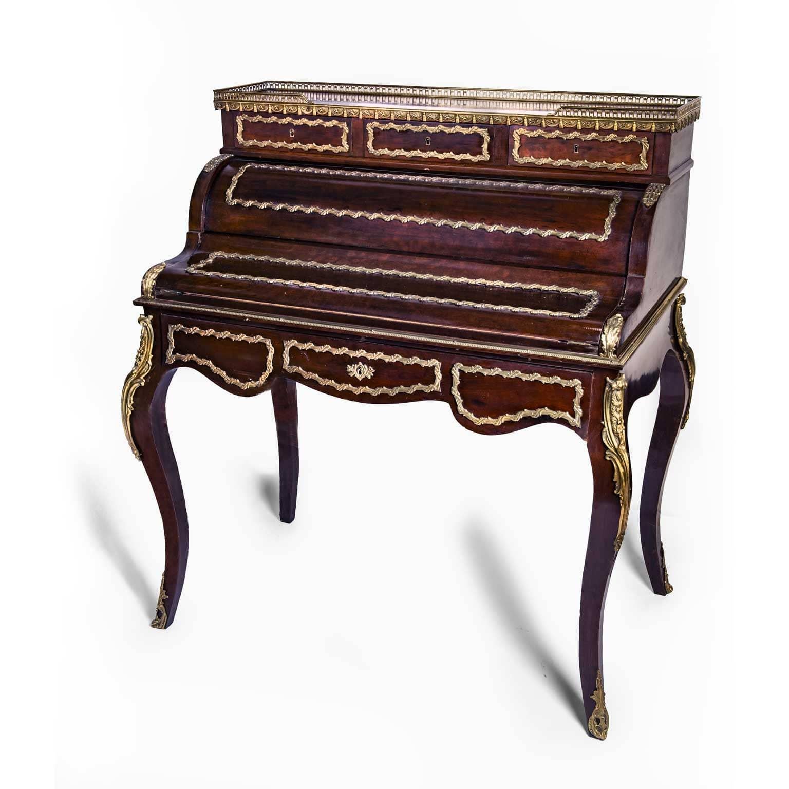 A late 19th century Napoleon III bronze-mounted mahogany bureau à cylinder, an elegant French Bureau de Dame or Bonheur du Jour, a ladies writing desk with cartonnier which opens up by sliding the central drawer. Inside, a writing table with dark