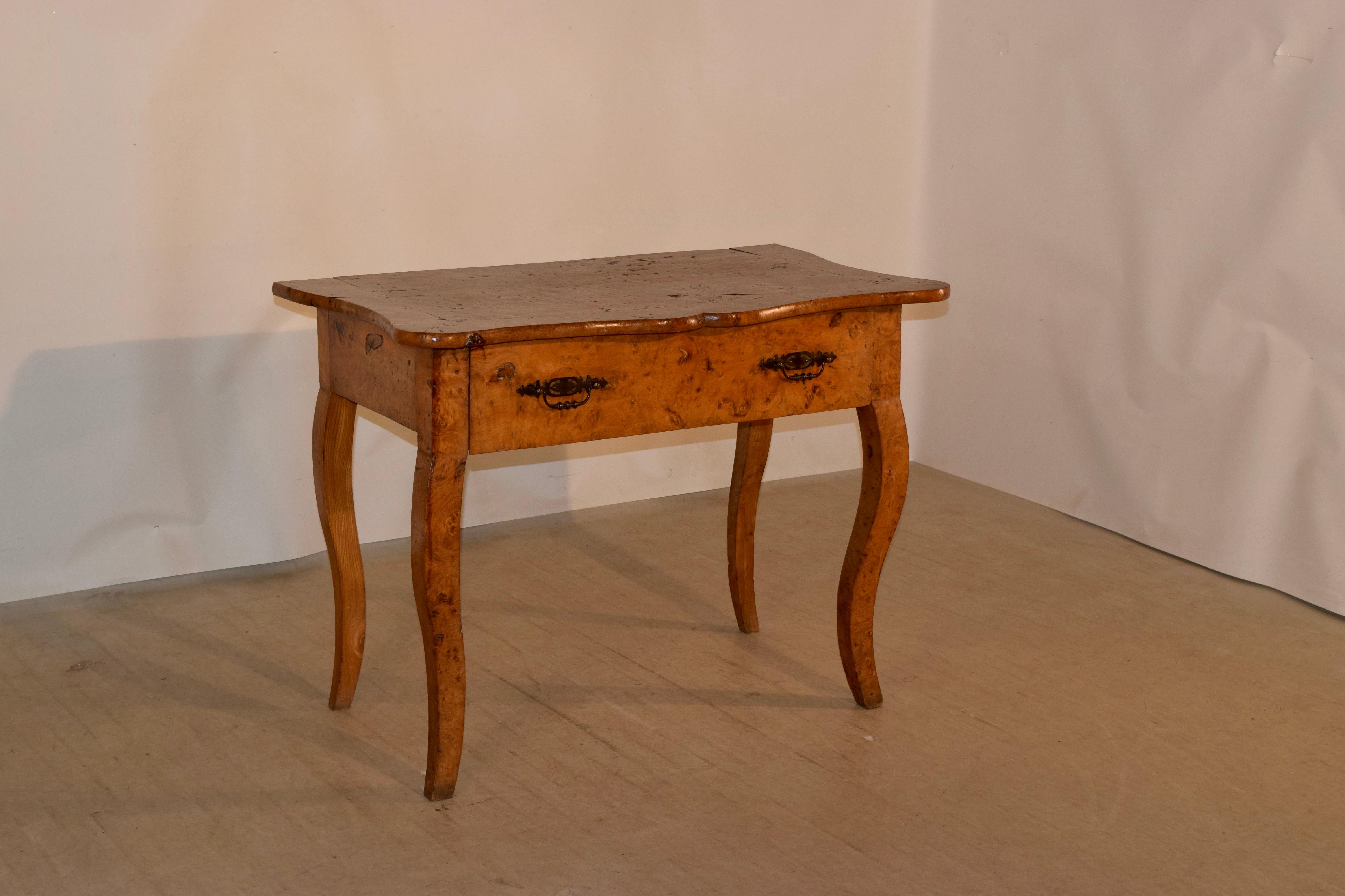 19th century burl elm console from France with a banded and scalloped edge around the top, following down to a single drawer in the front and simple sides, all supported on hand carved cabriole legs.