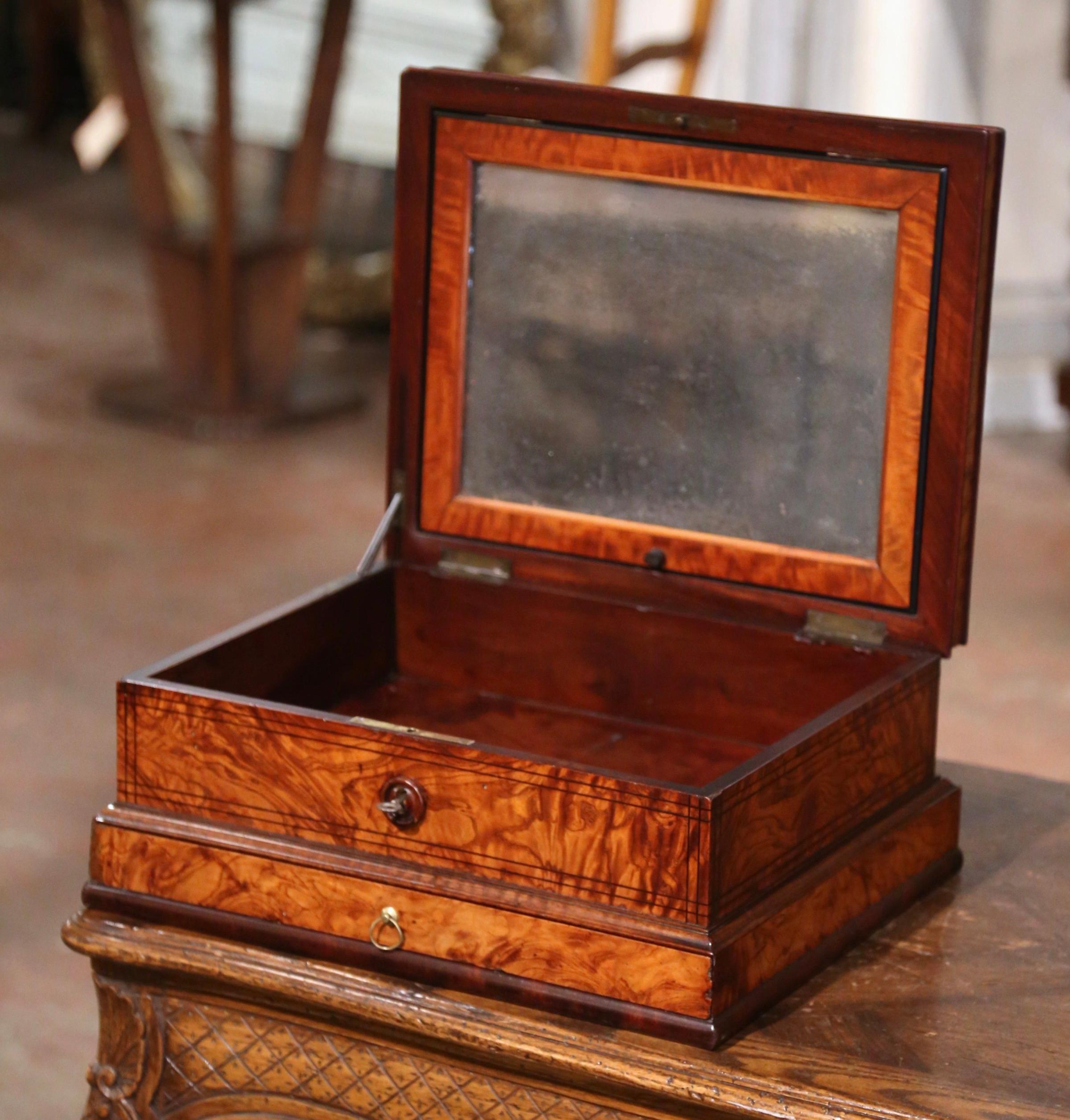 Decorate a coffee table or a shelf with this elegant antique box. Created in France circa 1880, the rectangular cabinet is decorated with an elegant floral inlaid star motif on the top. Opening the box, it reveals a large inside storage and a