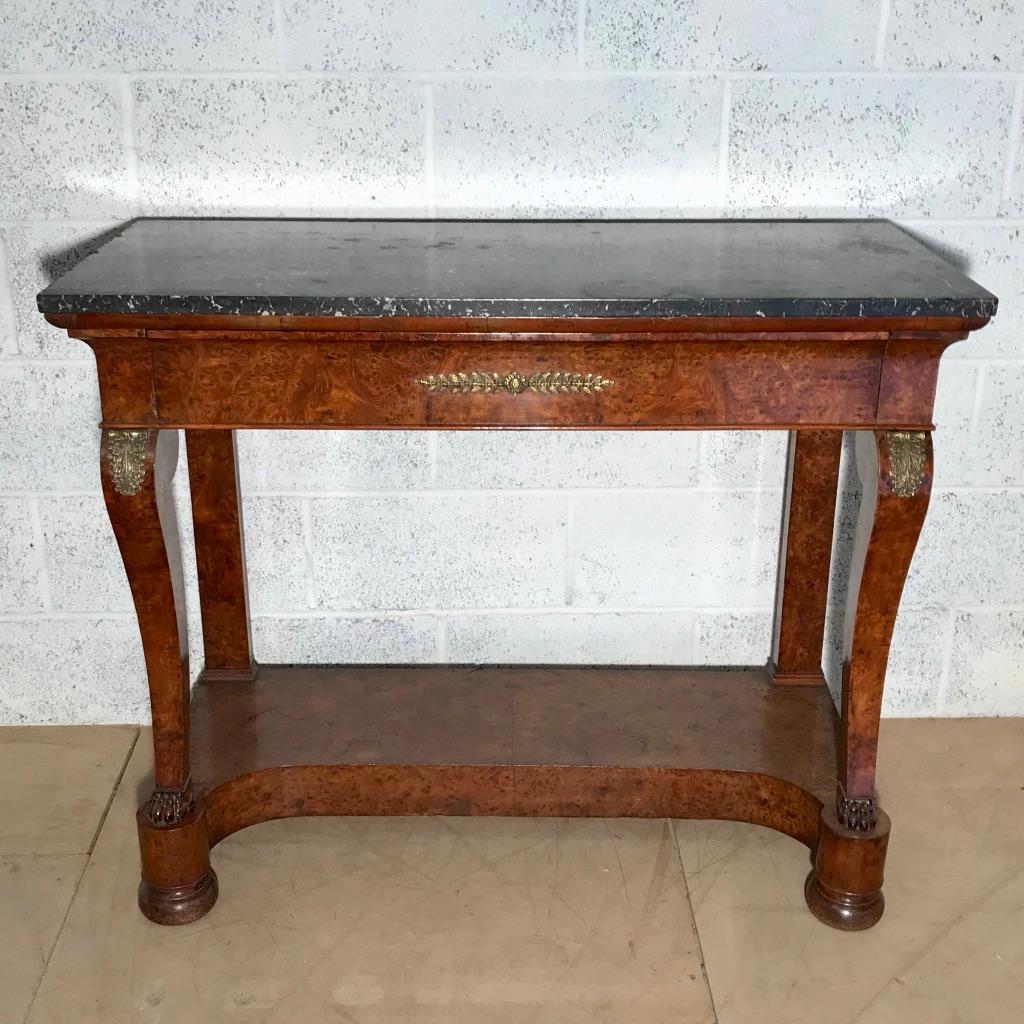 Nice quality and good size French late 19th century burr walnut console table in the Empire style with lovely scrolls to the front legs and carved lions paw feet.
There is a full width drawer to the frieze and the slim surface to the plinth base