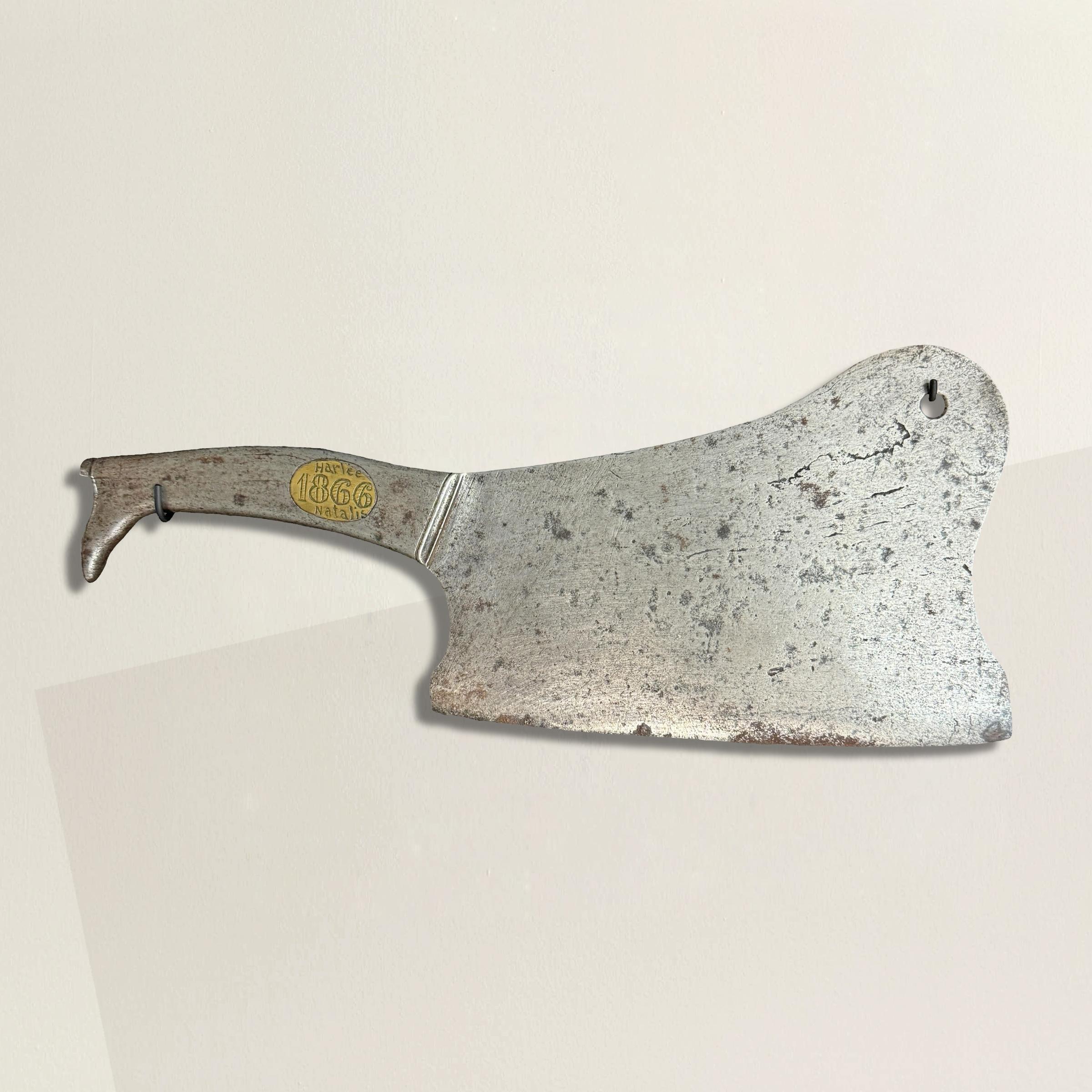 Ce hachoir de boucher en fer français du XIXe siècle est une pièce d'histoire remarquable, présentant un motif de botte unique sur le manche et une plaque de laiton encastrée, gravée du nom du boucher, 