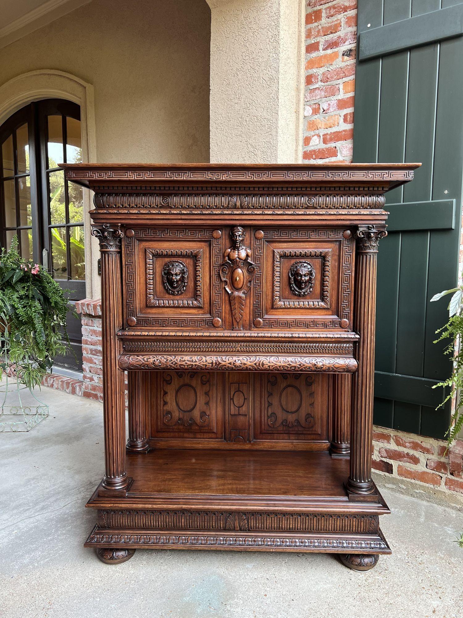 19th century French cabinet wine liquor greek key walnut regency sideboard.
 
Direct from France, a superb 19th century cabinet with outstanding Greek influenced carvings and elements throughout!
 
Four oversized, carved Corinthian columns frame the