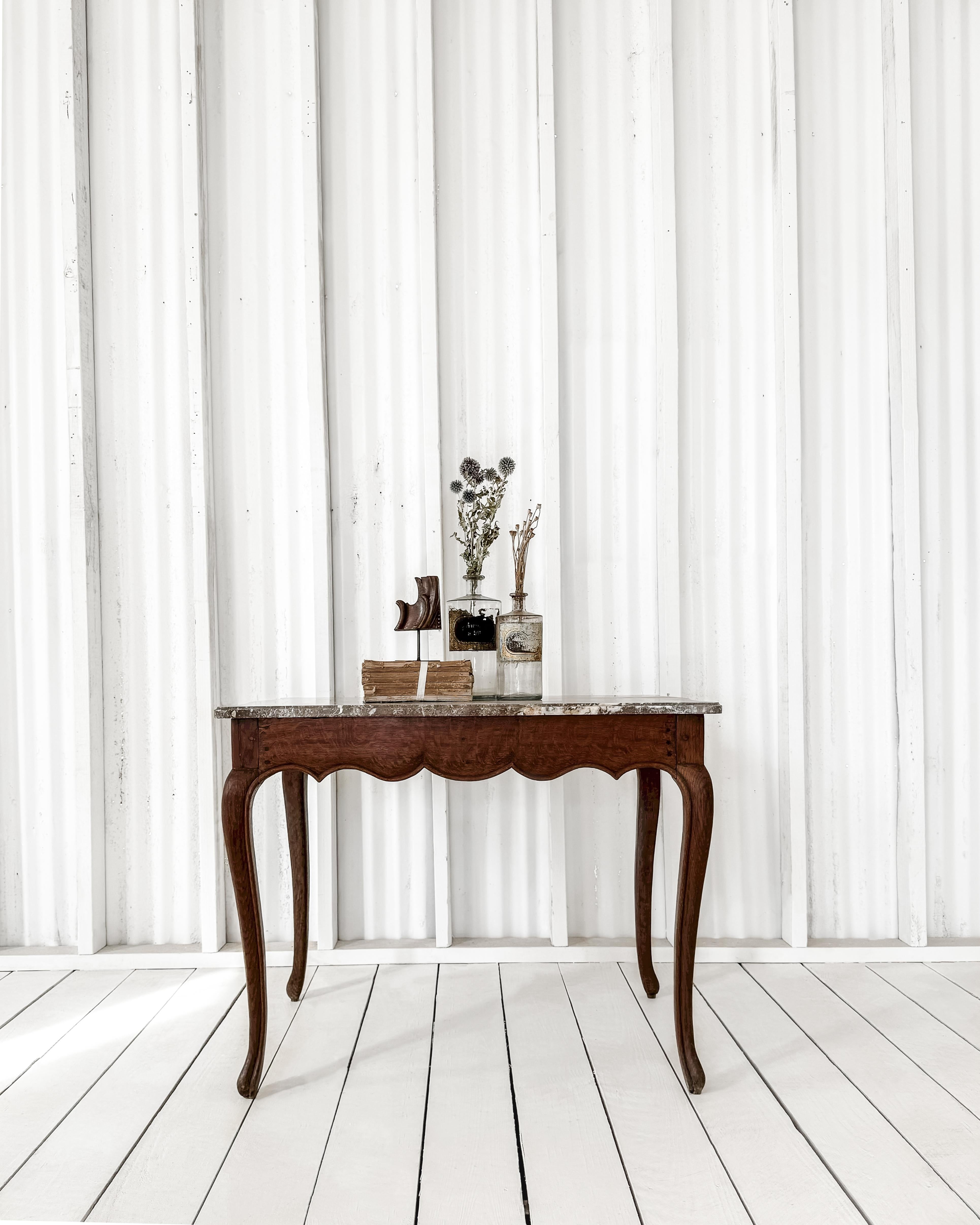 This stunning occasional table features graceful lines and a beautiful marble top that adds charm to any space. The shaped top is crafted from a rich Rojo marble, showcasing striking alabaster veining and an elegant ogee edge.

Perfect as an accent