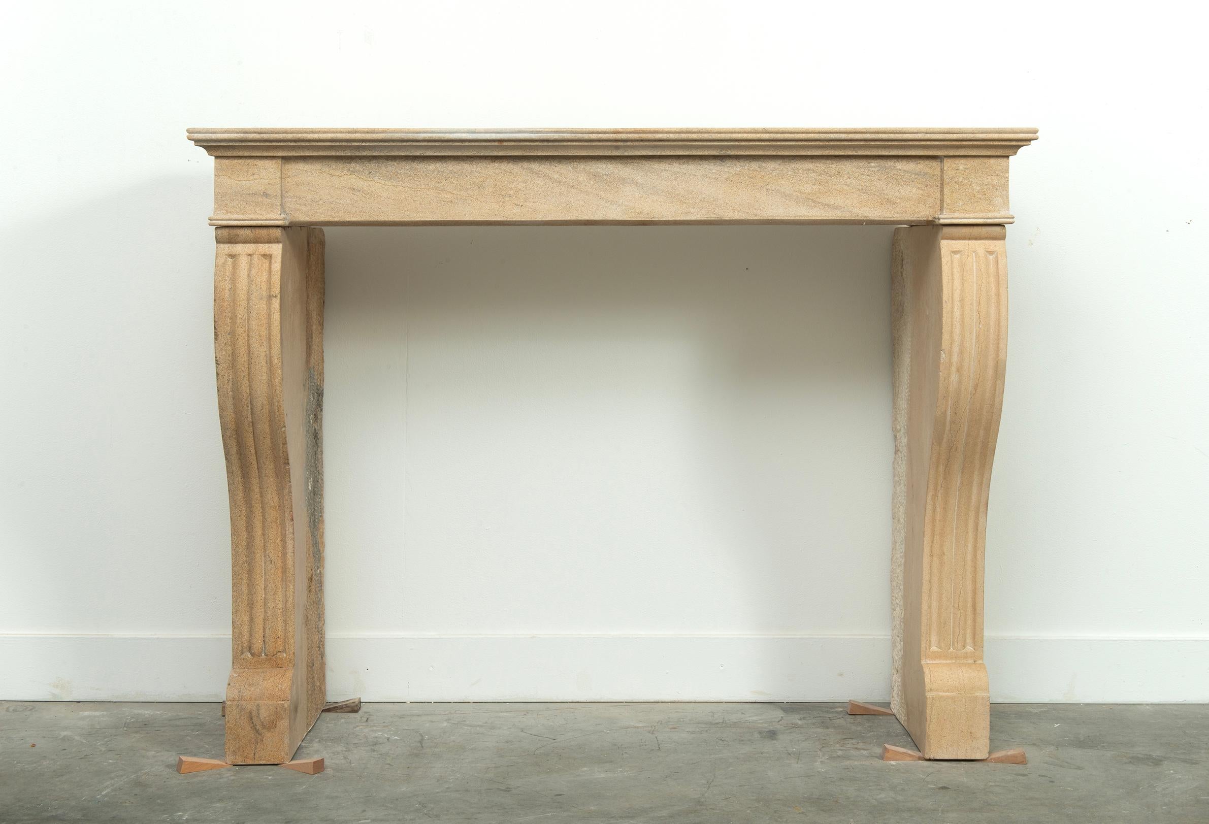 19th Century French Campagnard Limestone Fireplace with Sculpted Scroll Jambs

With rustic charm and timeless silhouette, this 19th century French fireplace mantel exemplifies the warm simplicity of Campagnard style—a countryside aesthetic rooted in