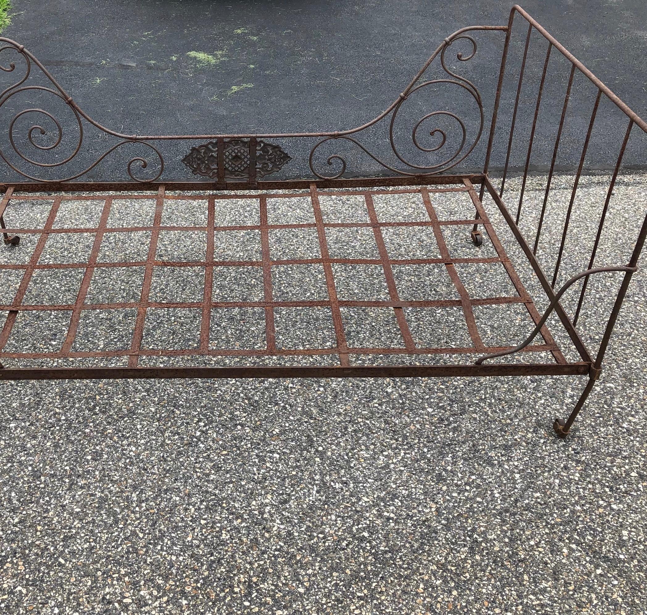 19th century French Campaign bed /daybed. Iron frame folds flat for storage.  Indoor or garden use. 
