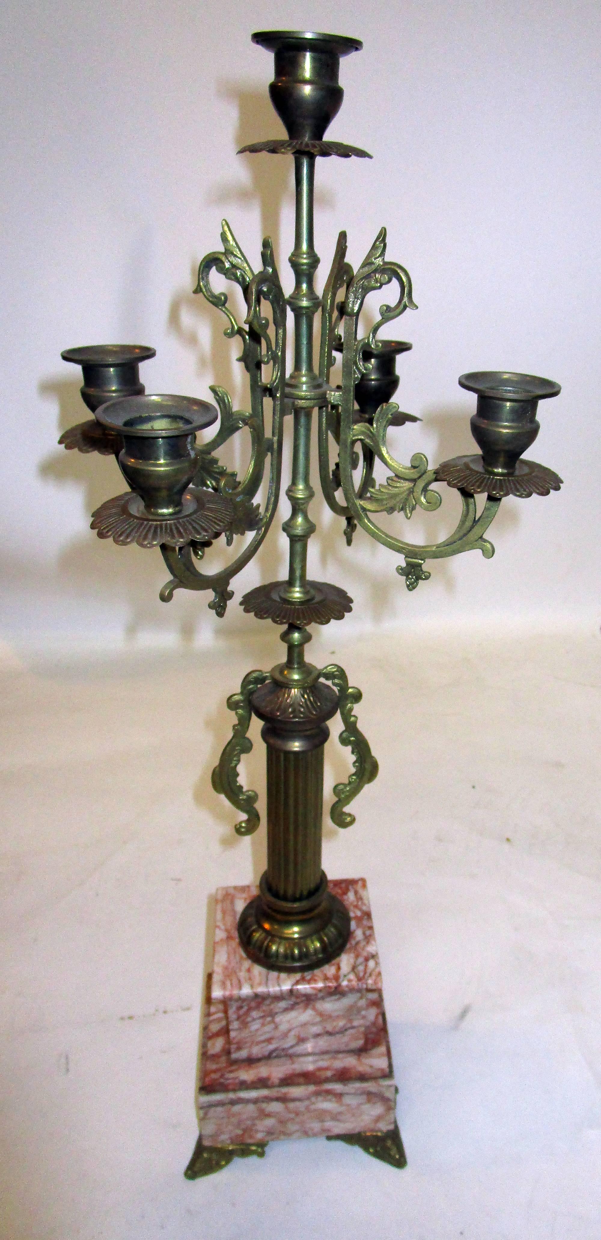 Handsome pair of 19th French mantel garniture feature heavy brass mounts with a serpentine design, Classic columns and five candle arms. The feet are curved in the front and straight in the back. The lovely rouge marble bases, further enhance these