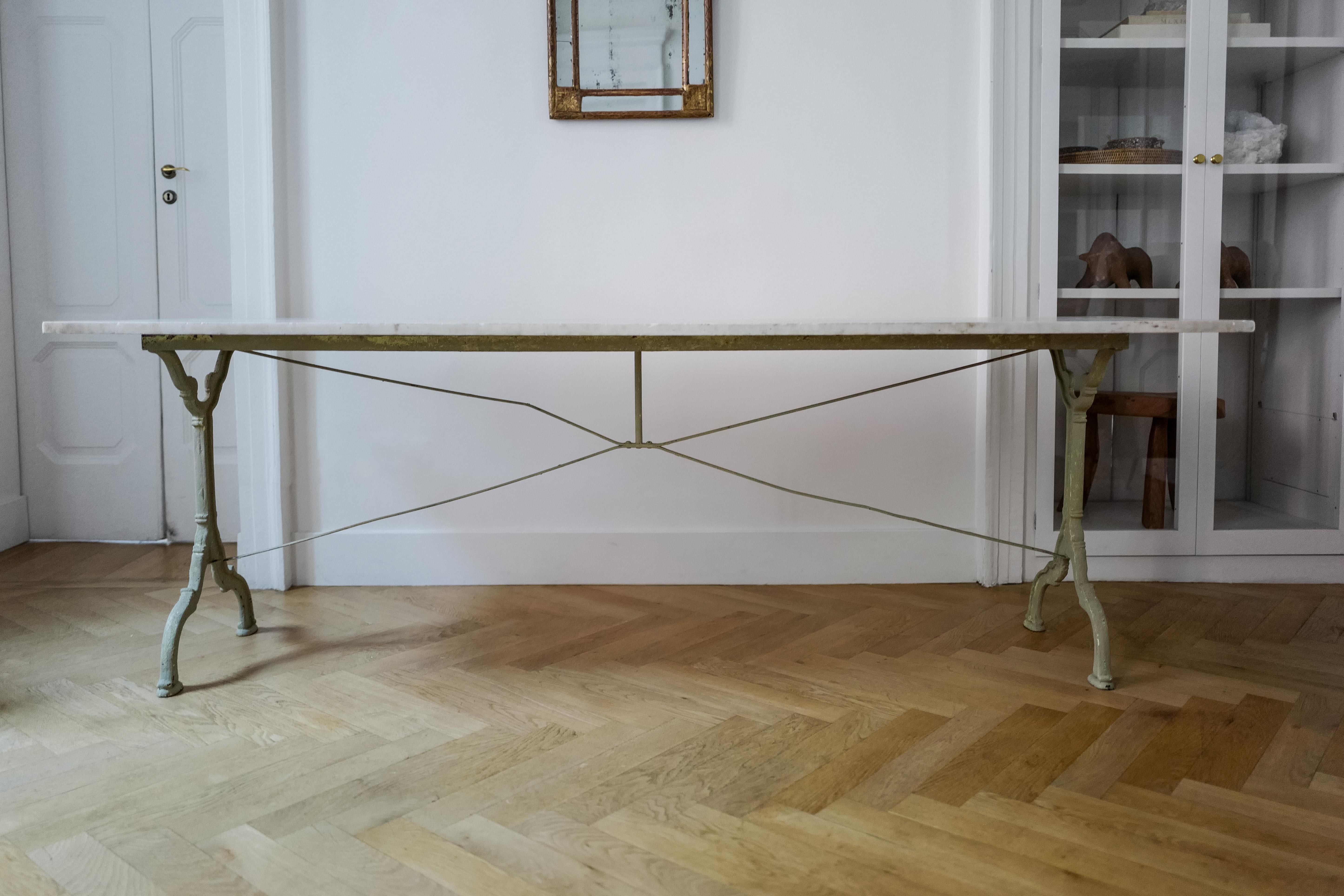 Beautiful 19th Century French garden dining table with a green/grey cast iron base and removable carrara marble top. Marble is heavy *