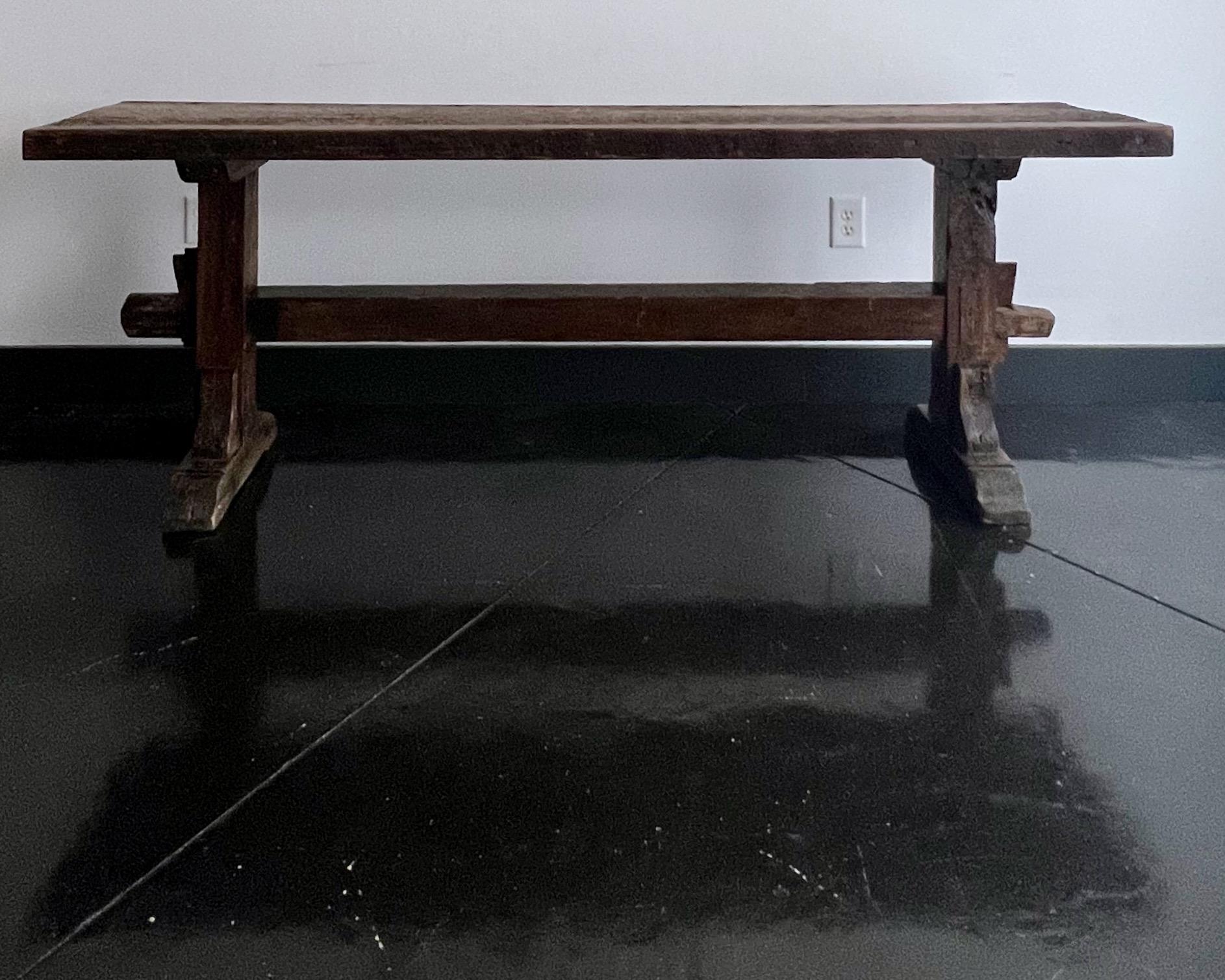 19th century French carpenter's workbench in timeworn patinated oak with very thick top with ten tool holes, traditional trestle legs - tenon and mortise construction.
It will be a focal point for use as console, sofa table or bar.
The table comes