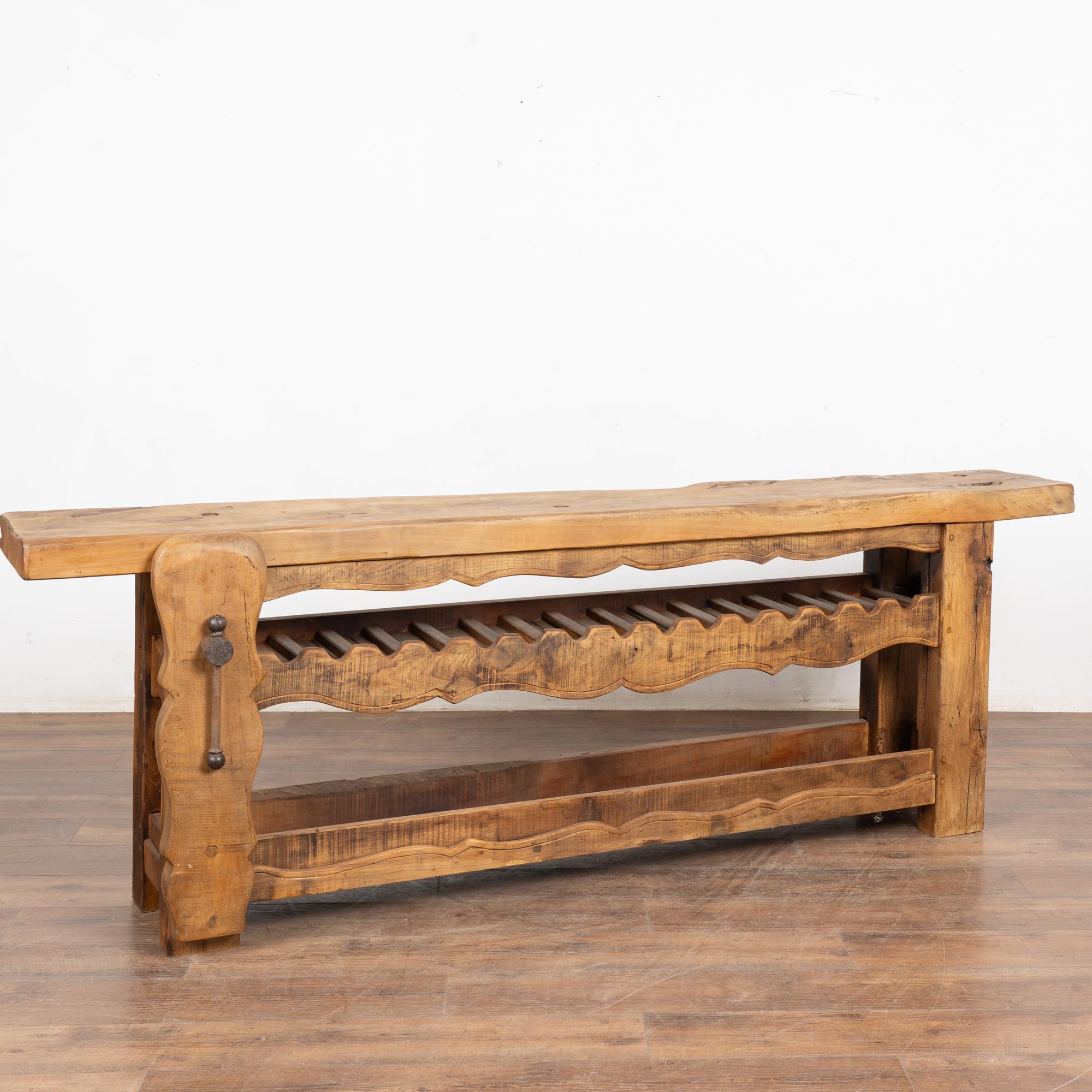 It is the years of constant use revealed in every ding, gouge, gnarl, deep crack, and scratch that enrich the character of this impressive carpenters' workbench from France.
Unique to this console is the (newer) two shelves with the upper serving as