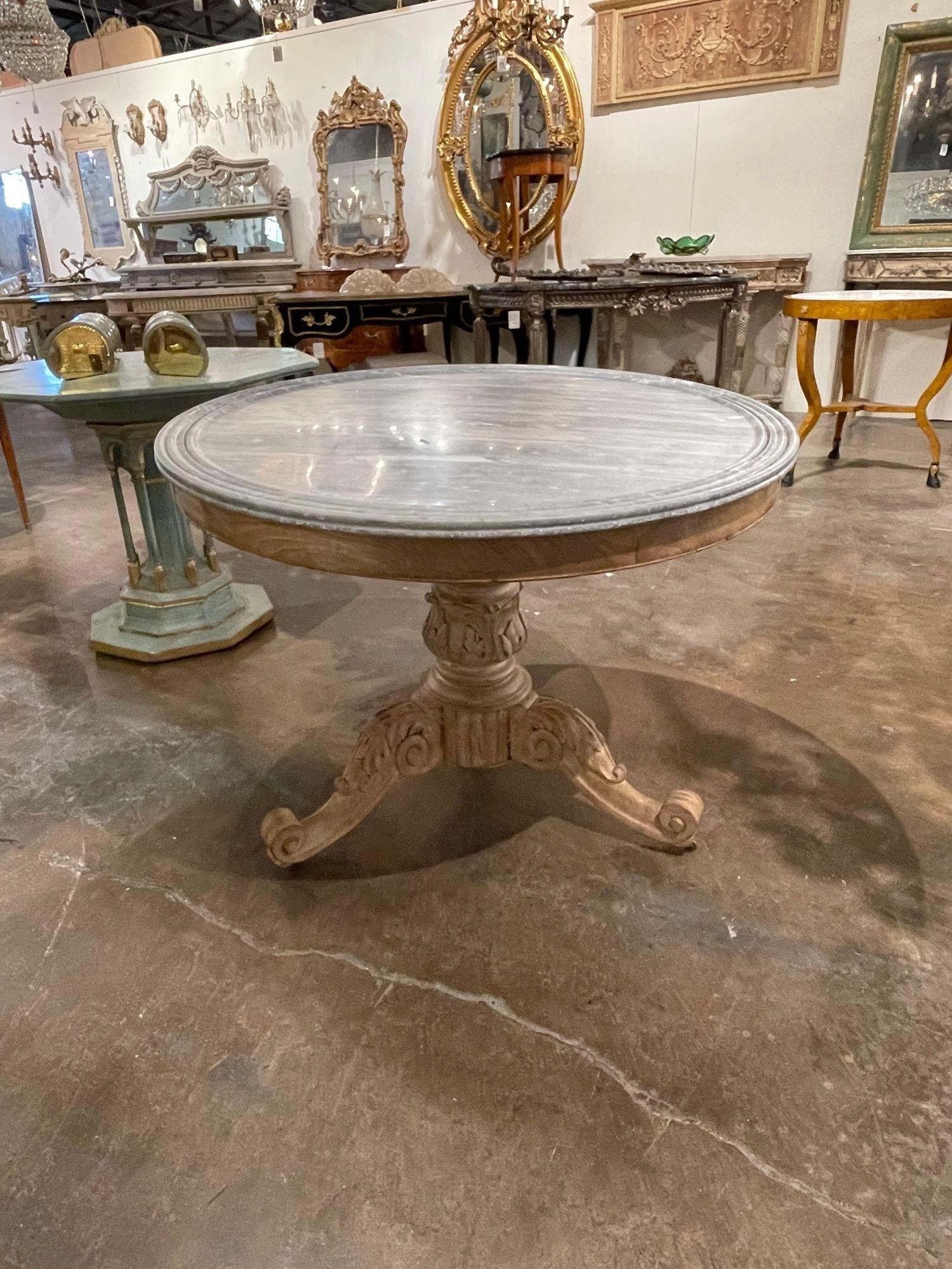Elegant 19th century French carved and bleached walnut center table with a marble top. Beautiful carvings on this piece. Exceptional for a fine home!.