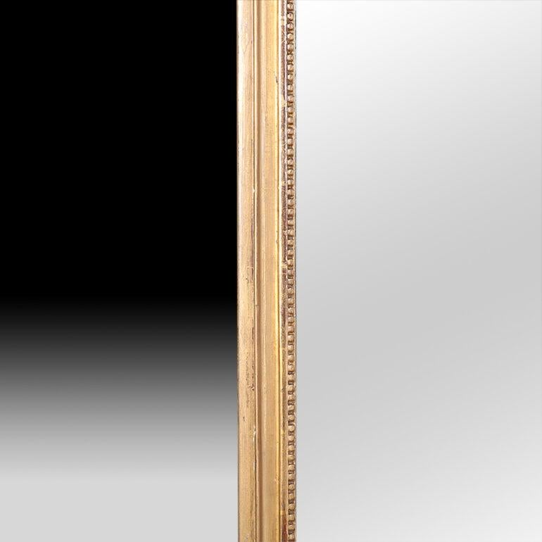 A 19th century French gilt-framed wall mirror with urn detail.

 
