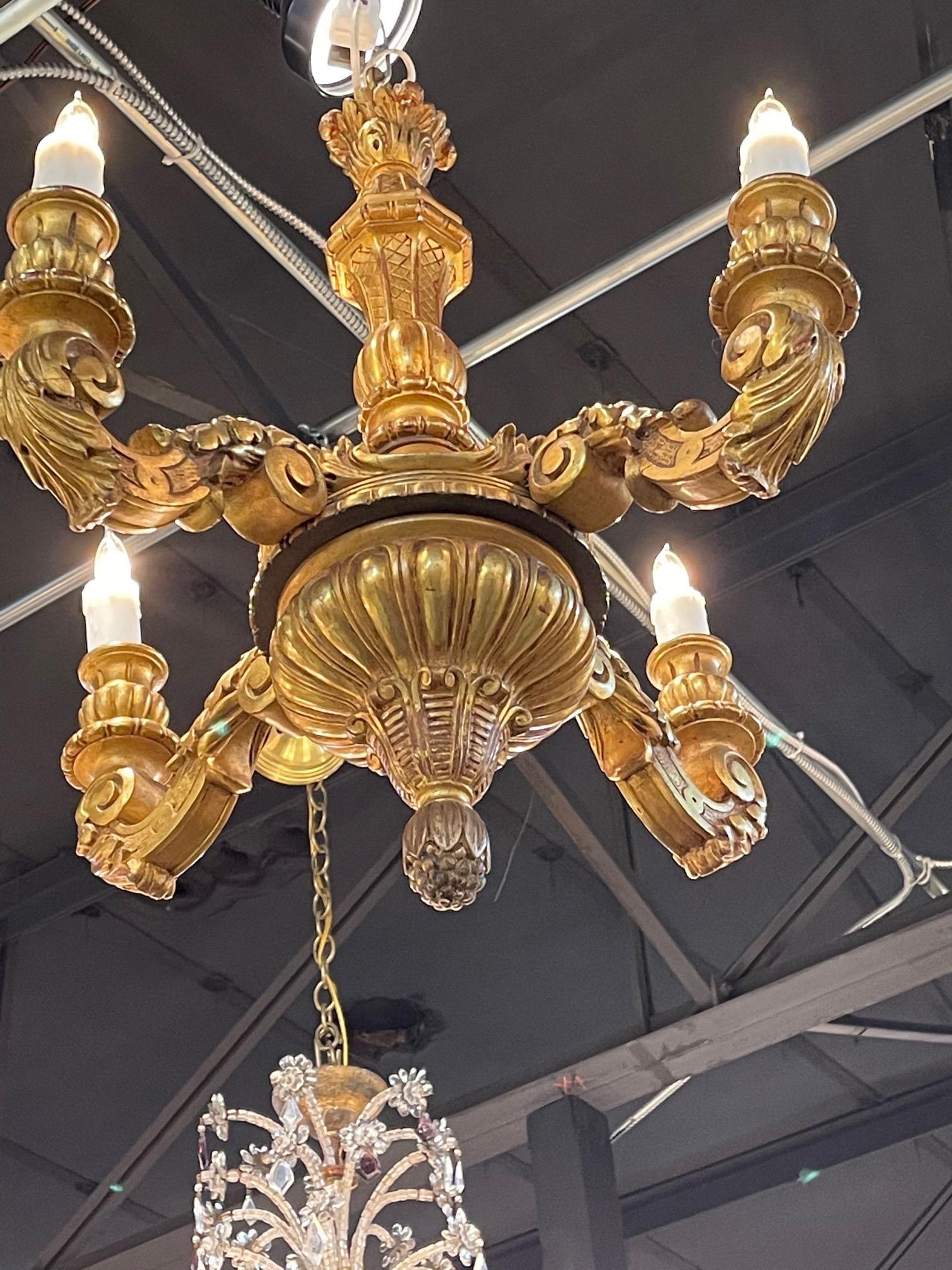 Gorgeous carved and giltwood chandelier with 4 lights. Exceptional carving on this piece. Very fine quality and a true work of art!