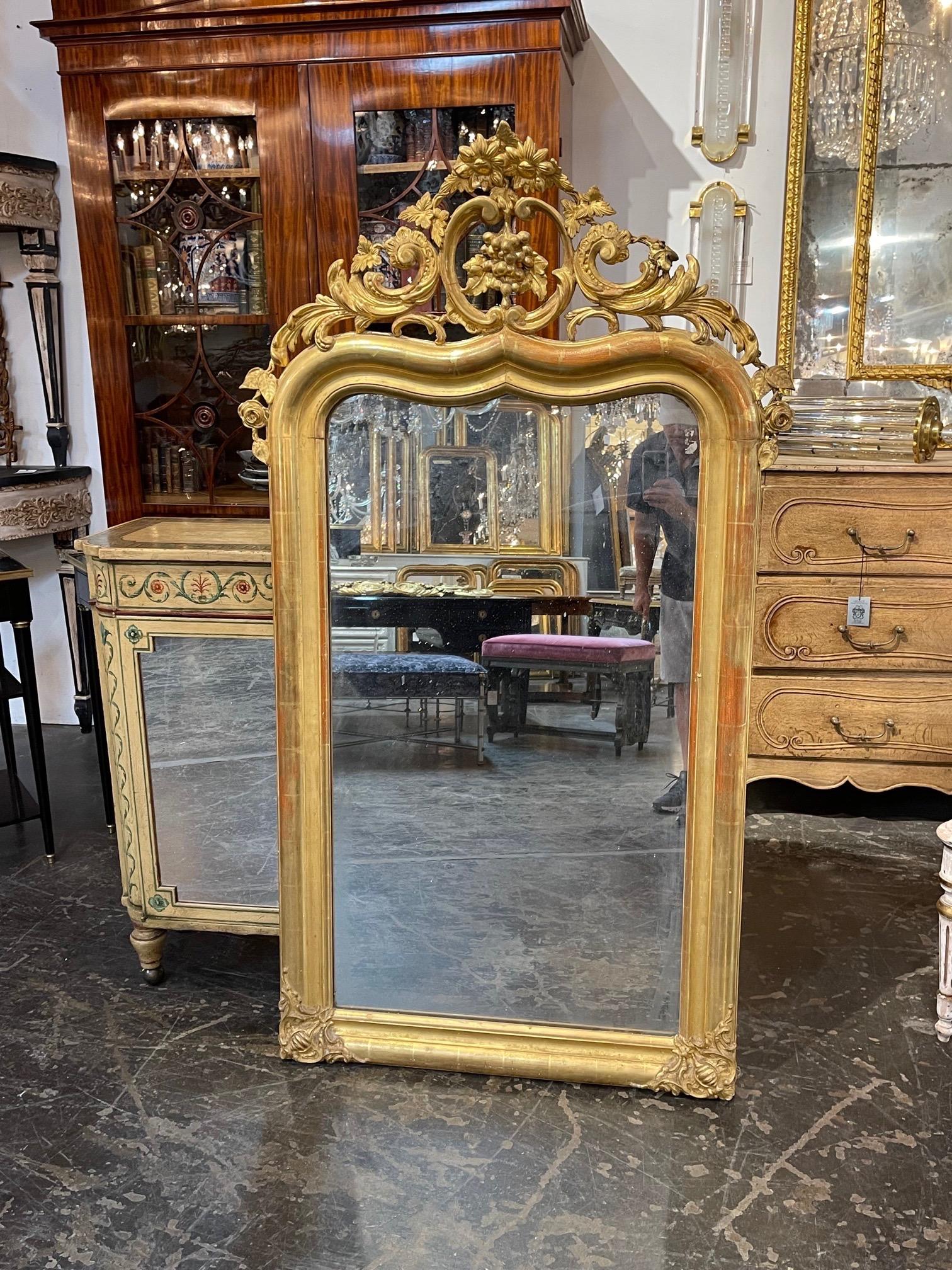 Decorative 19th century French carved and giltwood Louis XV style mirror. Amazing carvings including flowers, grapes and leaves. A very impressive piece!