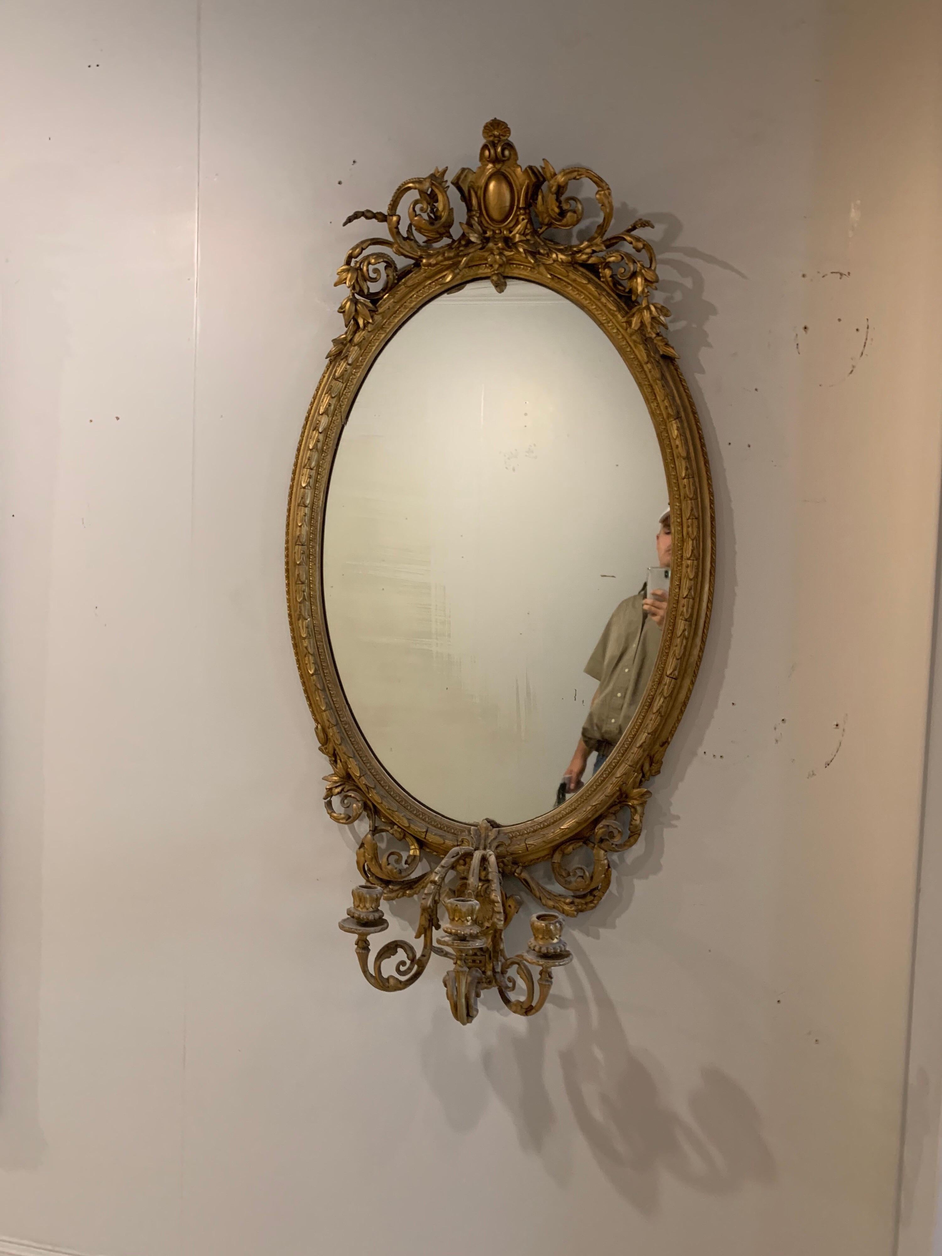 20th Century 19th Century French Carved and Giltwood Oval Mirror with 3-Arm Sconce For Sale