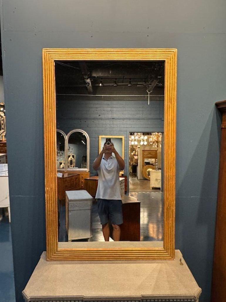 Experience the elegance of the 19th century with this exquisite French carved and giltwood transitional mirror. Its classic design is perfect for those who appreciate the beauty of antique furniture. Adds a touch of elegance and also mixes well with