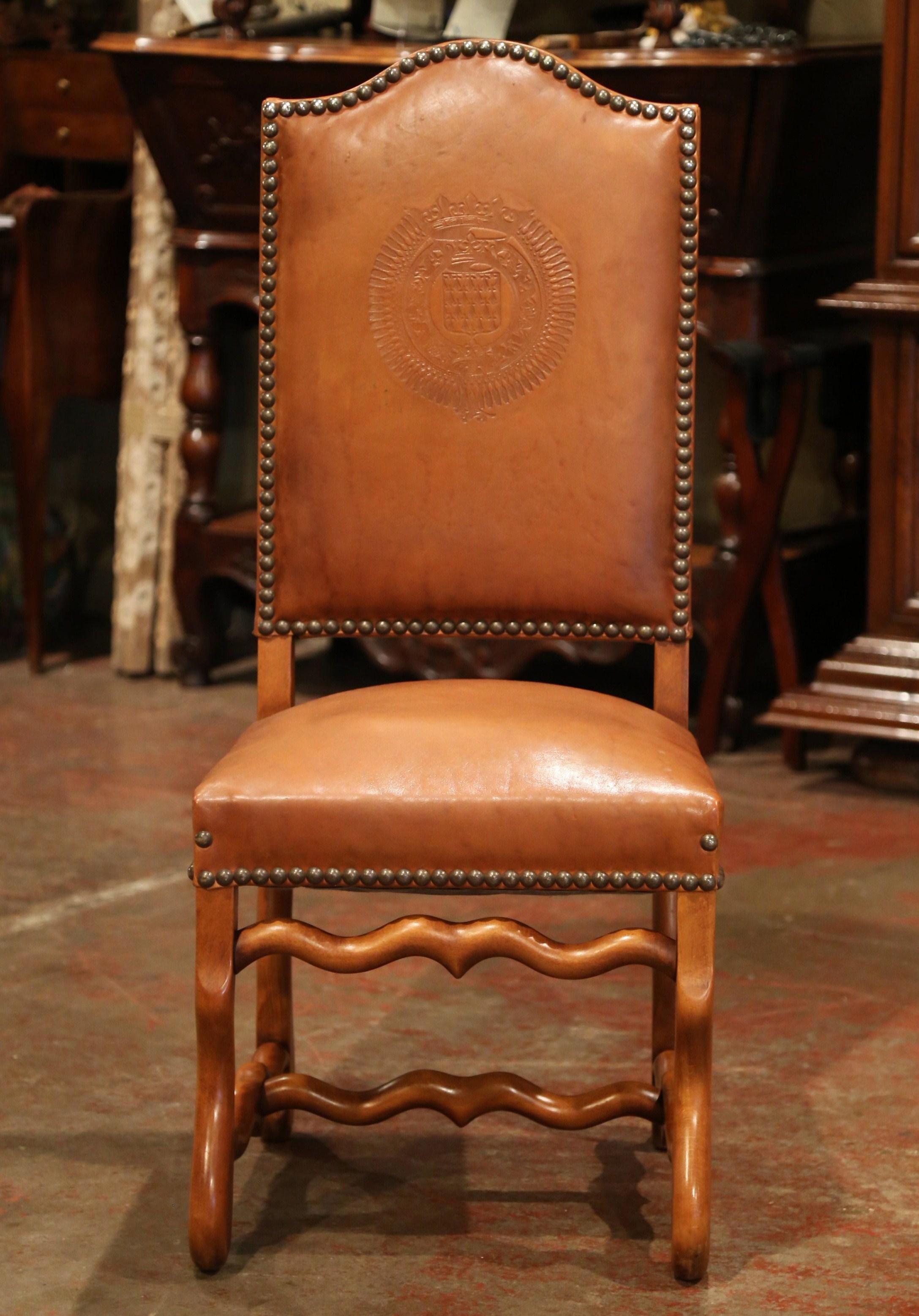 This elegant suite of antique chairs was crafted in France, circa 1880. Each of the eight side chair has a tall arched back and features carved 