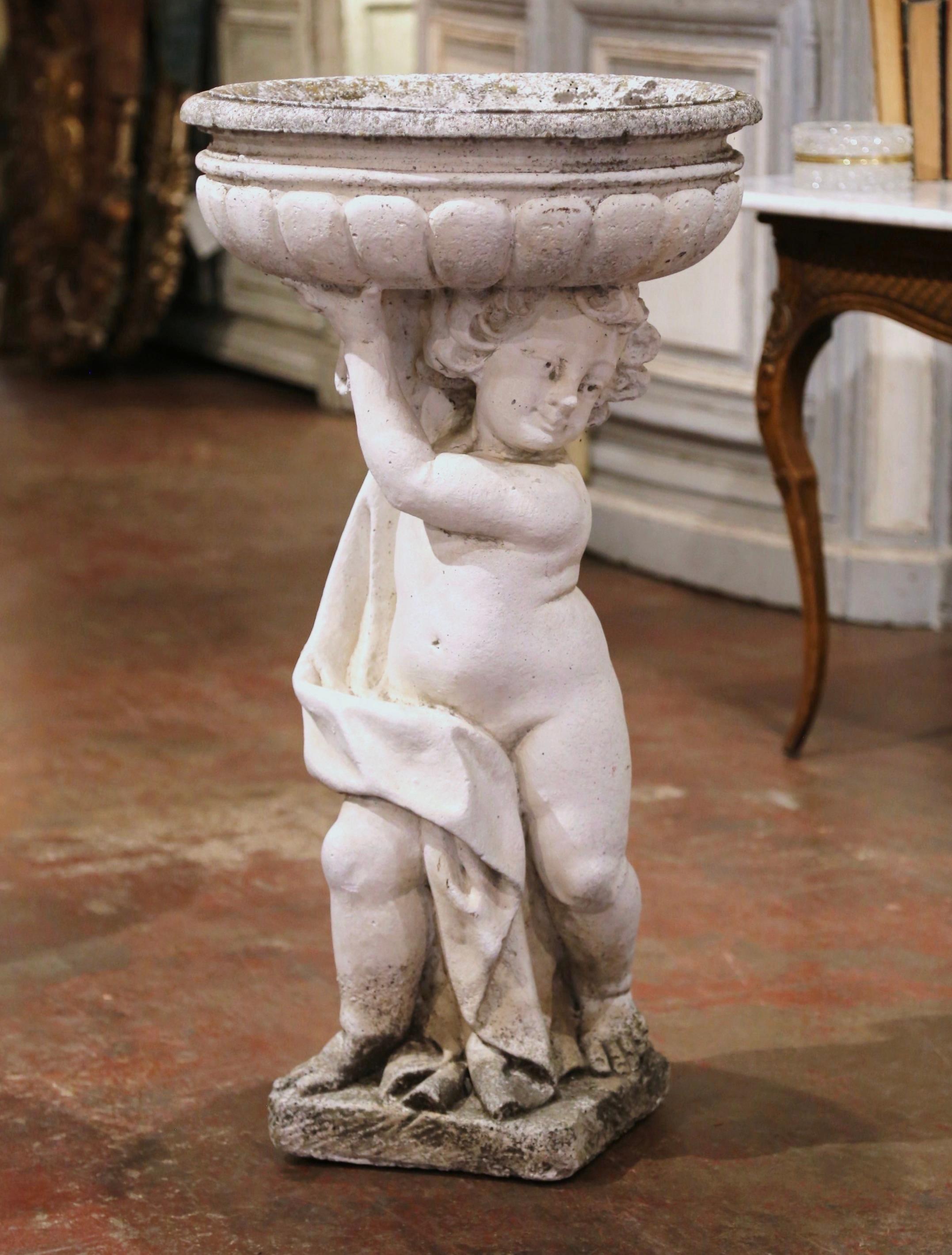 Decorate a garden or a patio with this large and elegant antique planter. Crafted in Normandy France, circa 1860, and built in one piece, the tall stone flower pot stands on a square base, and features a carved draped putto holding the basin. The