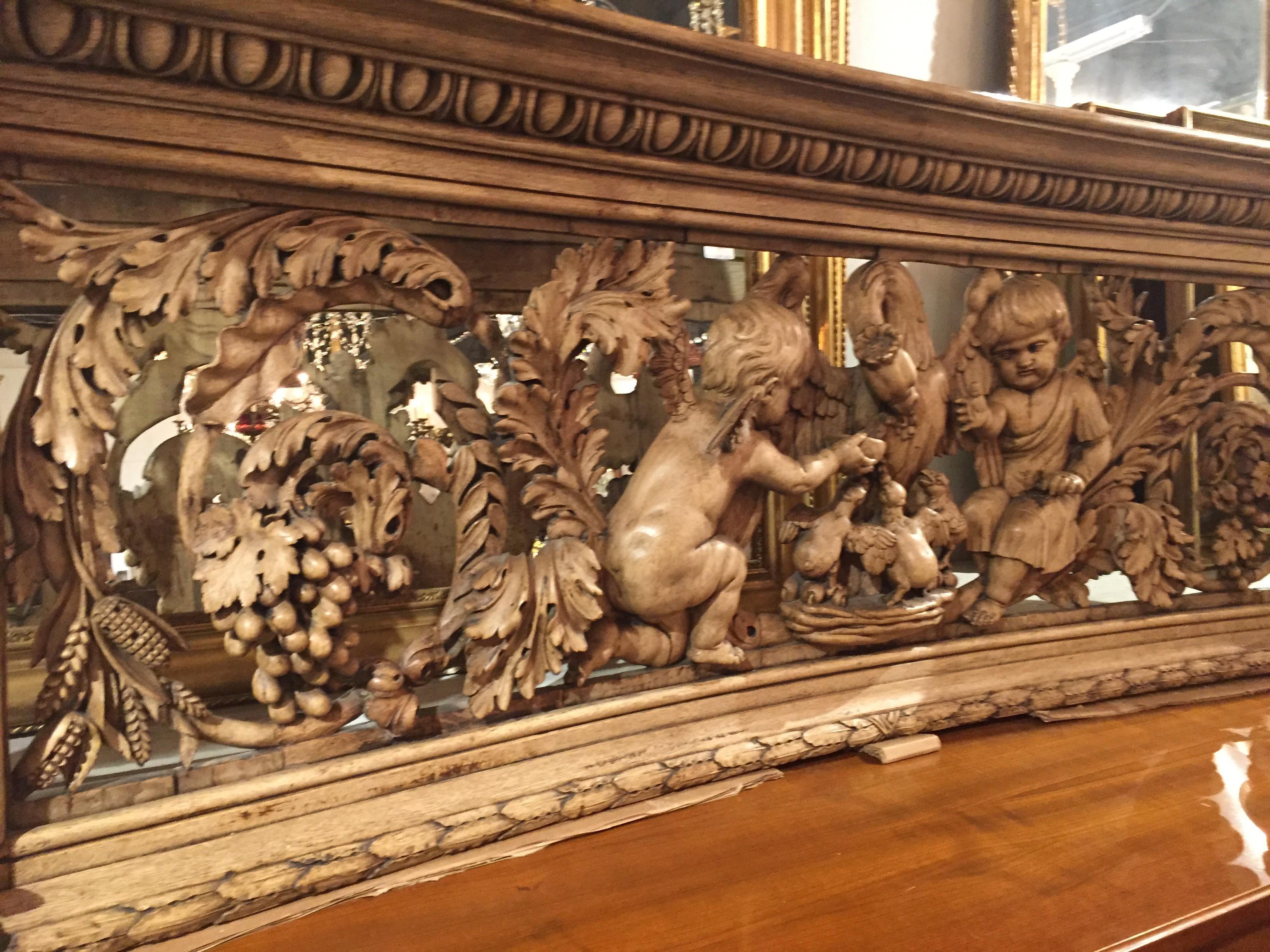 An incredible hand carved bleached oak architectural panel from France. Depicts a scene with cherub children and a mother goose and her goslings. On the edges are a carving of a women and a man. An amazing display of Fine craftsmanship. One has to