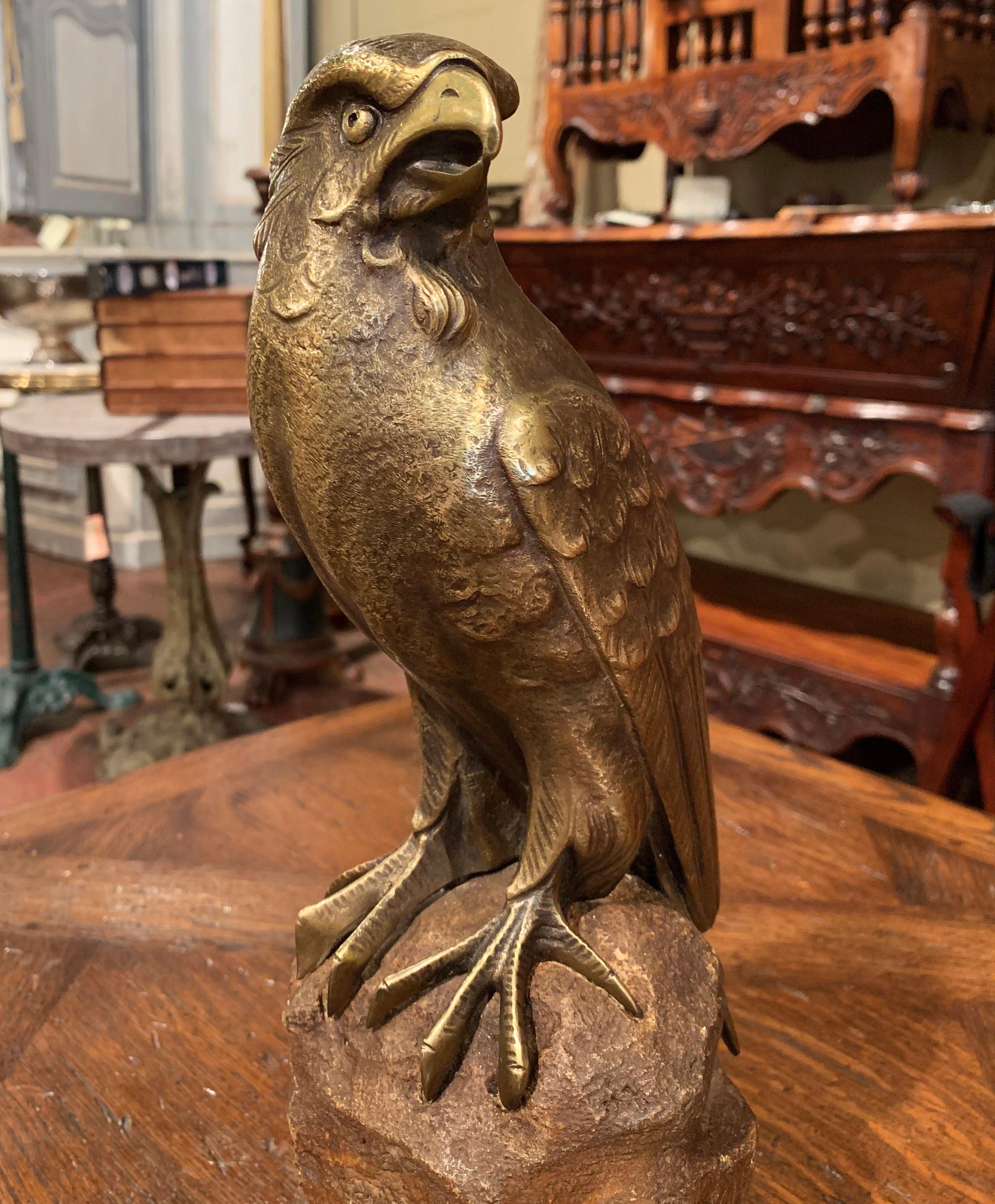 Decorate a shelf or a man's desk with this stately antique bird sculpture on stand. Crafted in France circa 1880, the carved sculpture features a picturesque bronze eagle standing proudly on a rock made of stone. The realistic avian figure has