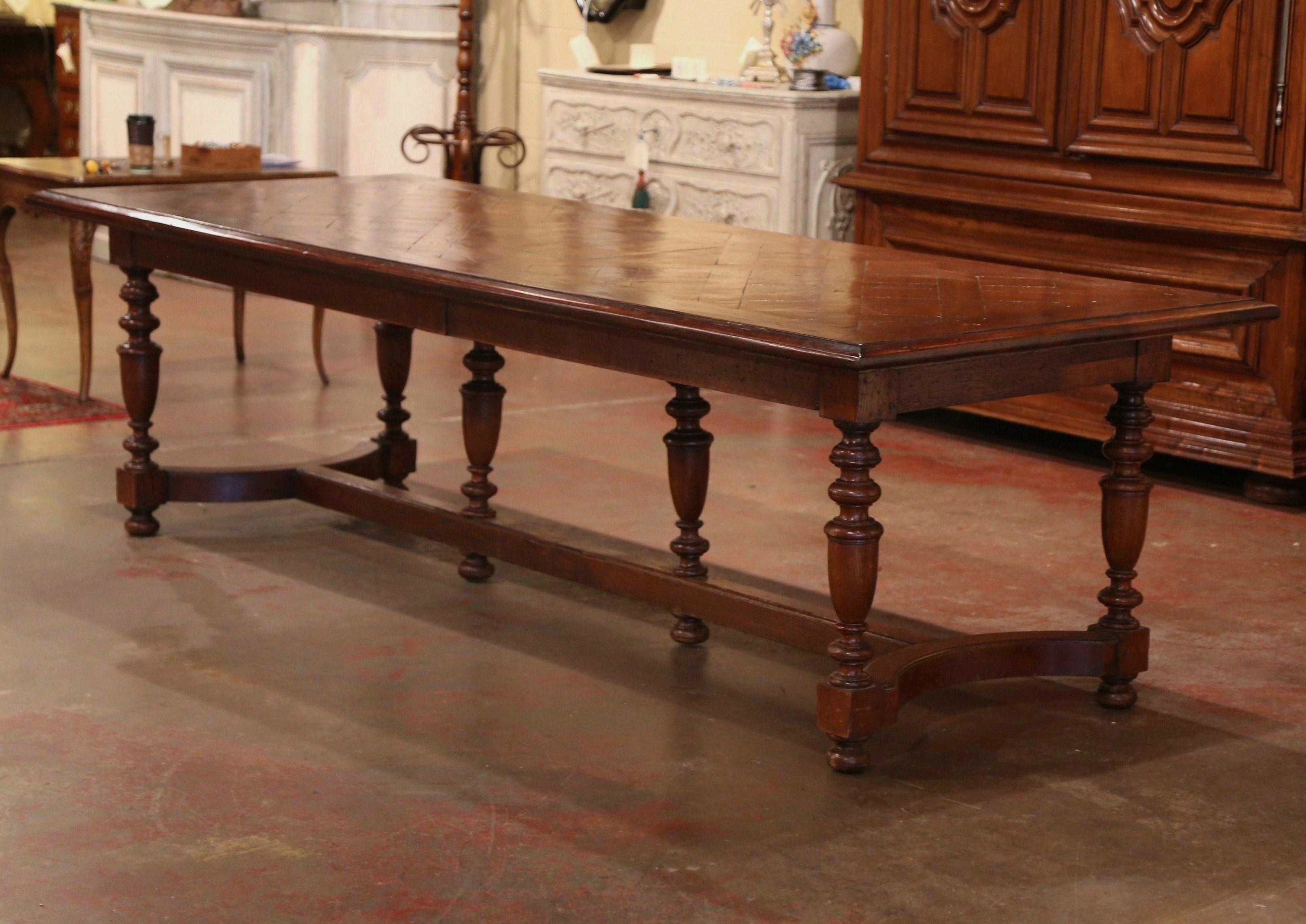 Make a sophisticated statement in your home with this long, rectangular fruit wood rectangular dining room table. Carved in France, circa 1870, the large and wide Louis XIII table stands on six carved turned legs (including two in the center), and