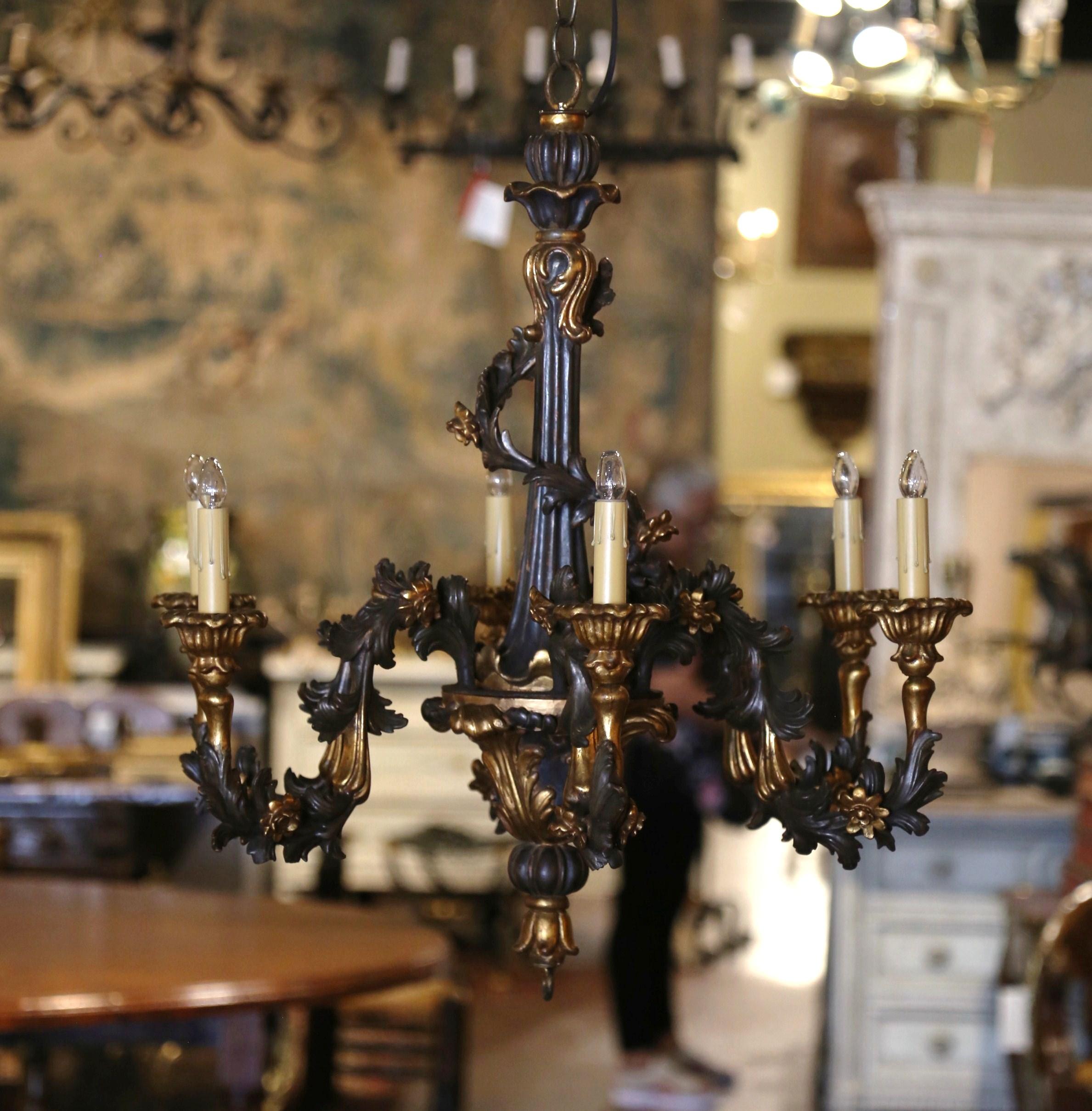 Decorate an entry, dining room or a powder room with this elegant antique wooden chandelier. Crafted in France circa 1880, the delicate light fixture is round in shape and features six arms of equal lengths around the thick intricately carved