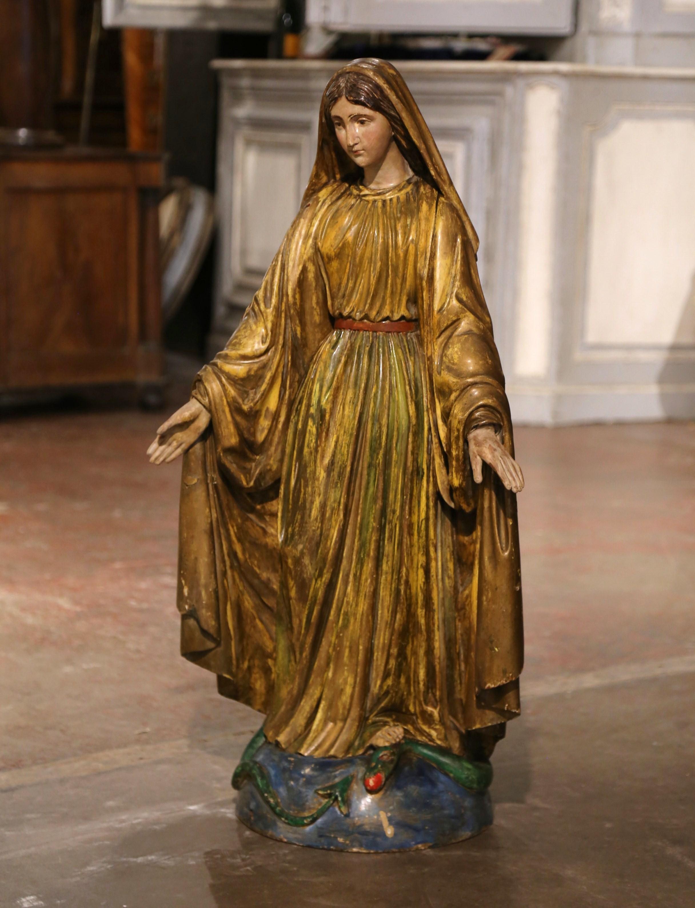 Over three feet tall, this important antique sculpture of the Virgin Mary in prayers was created in Provence, France, circa 1860. Embellished with gold leaf and polychrome finish, the large religious figure is beautifully ornate and has wonderful