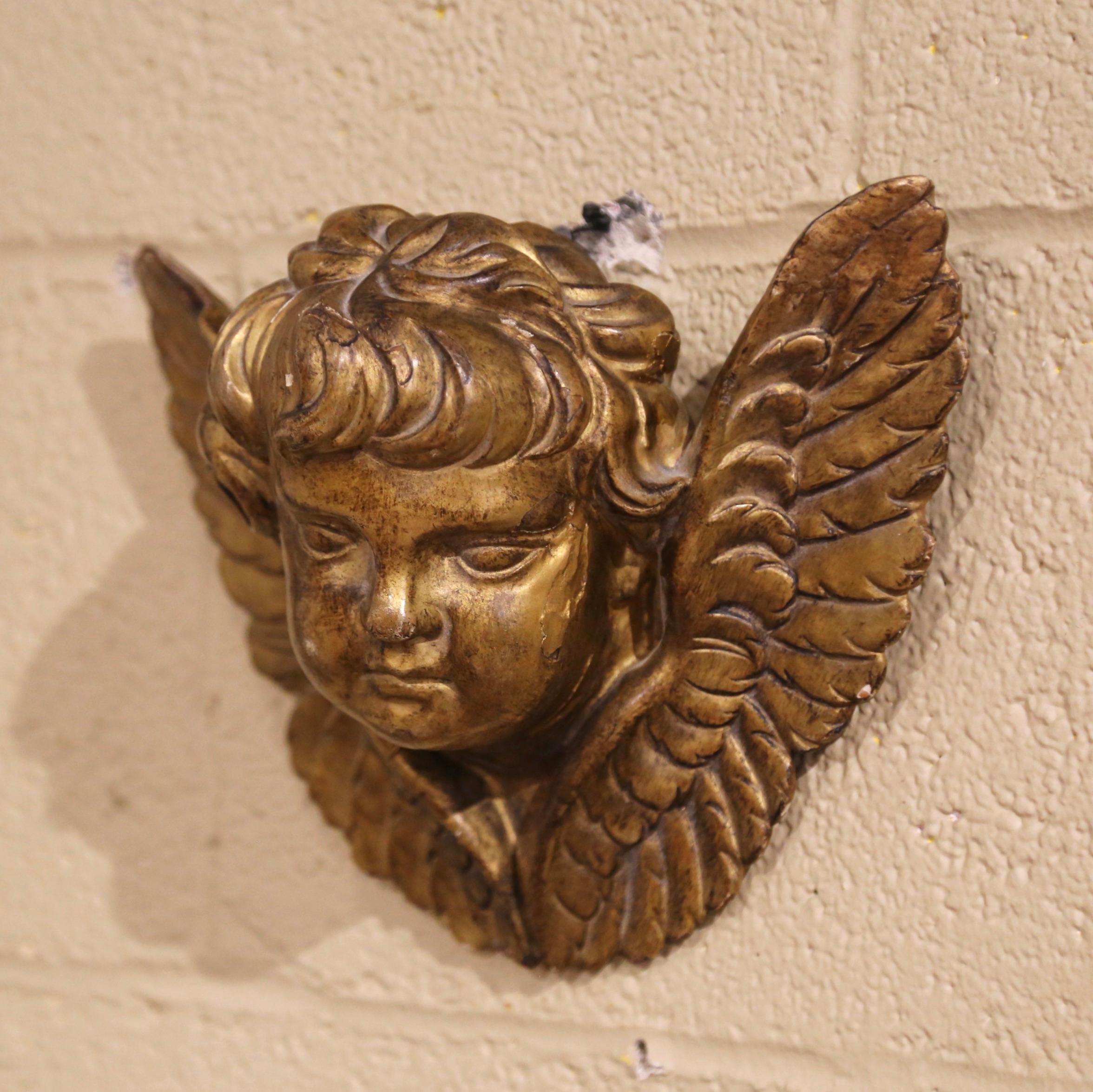 This antique religious sculpture was crafted in France circa 1860; the wall hanging carving features a hand carved cherub face with wings. The elegant putti is in excellent condition and adorns the original patinated gilt finish.
Measure: 10