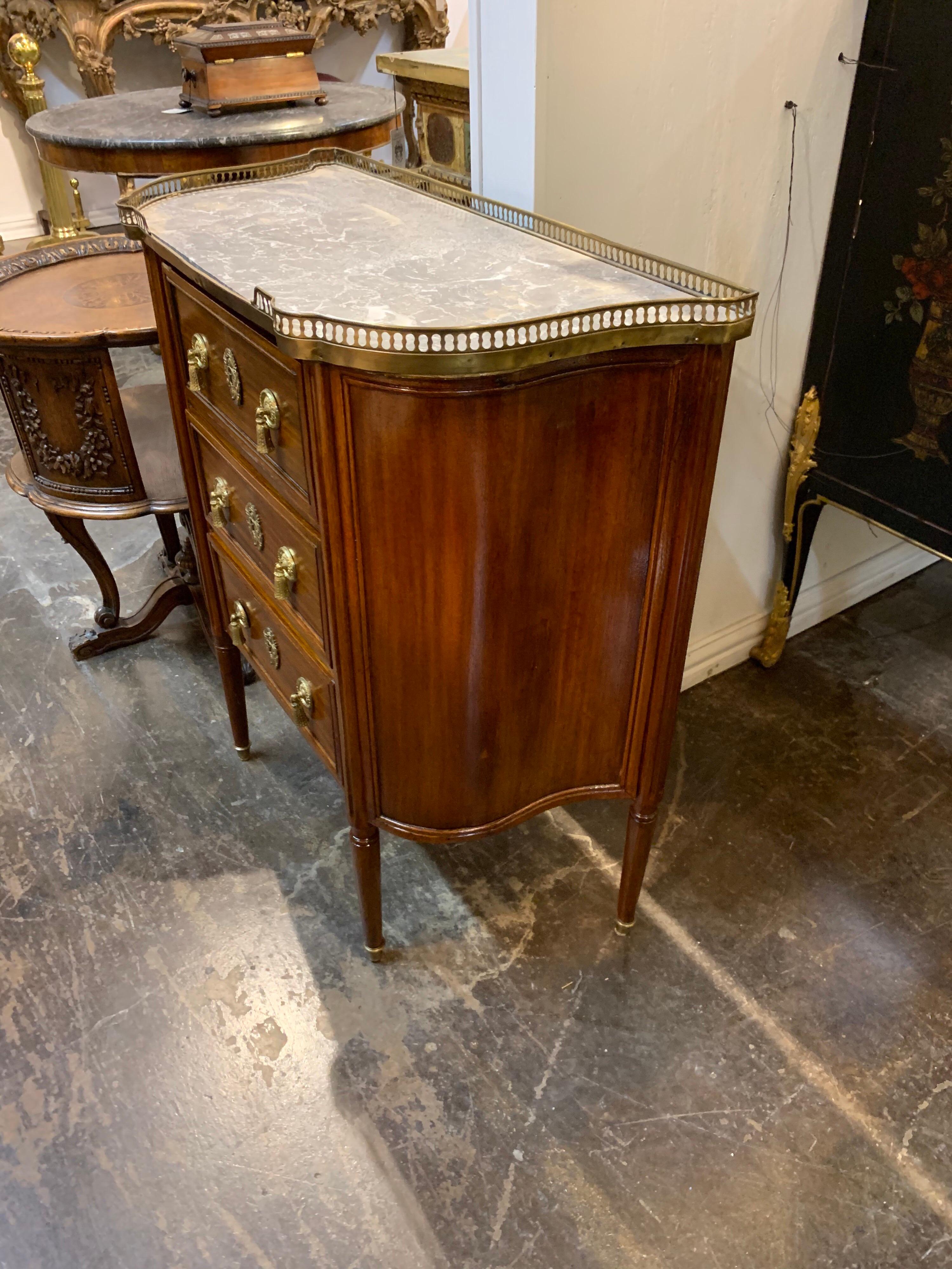 Lovely 19th century French carved mahogany Directoire' style side cabinet with original grey marble top. Great finish on the piece and beautiful brass hardware. So stylish for a variety of decors!
  