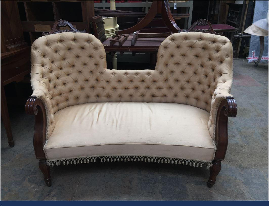 19th century French carved mahogany wood capitonné sofa with wheels, 1890s.