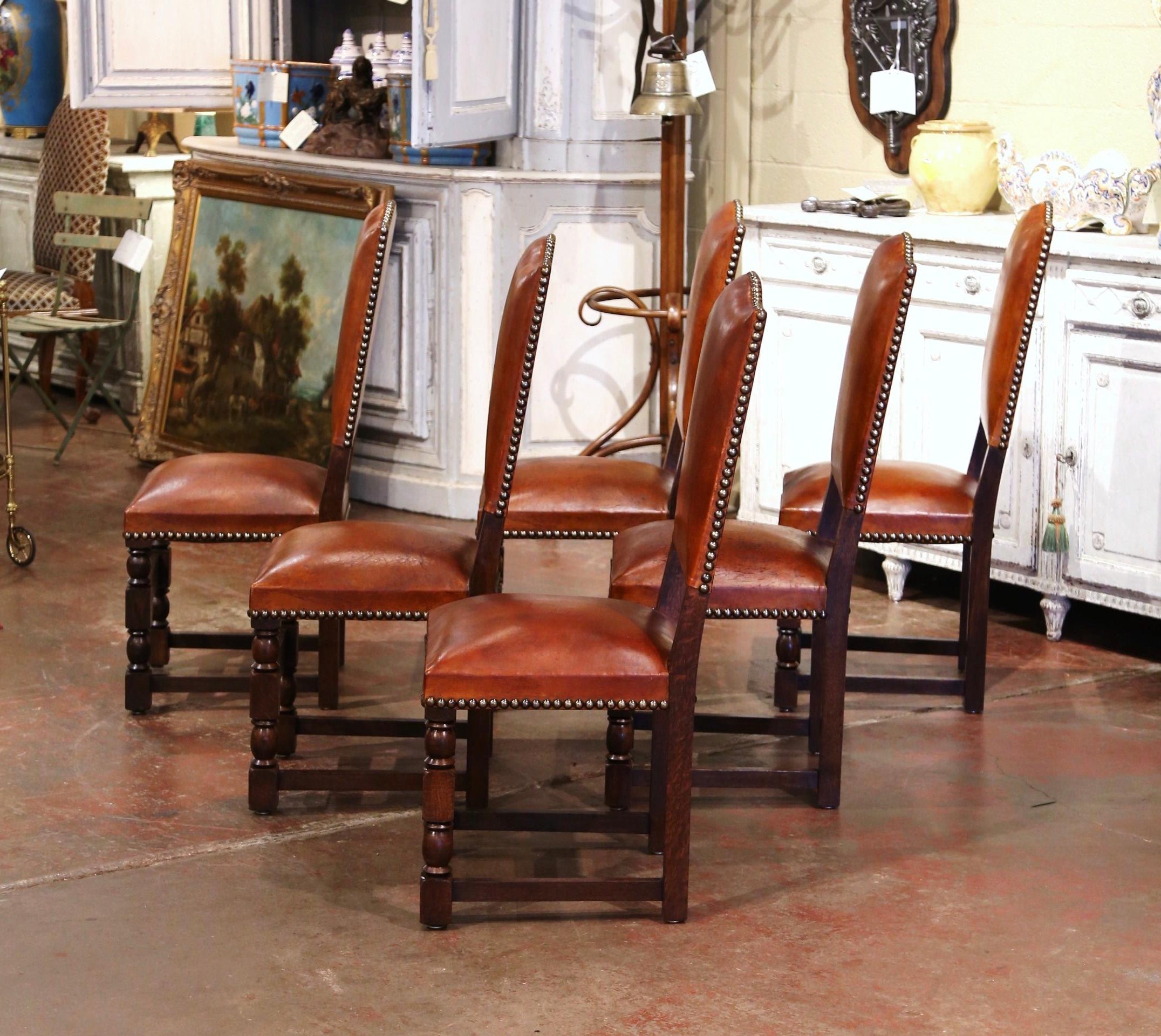 Dress a dining table with this elegant suite of antique chairs. Crafted in France, circa 1880, each side chair stands on front turned legs, and is decorated with a carved front stretcher. Each chair has a tall arched back and deep seat, both