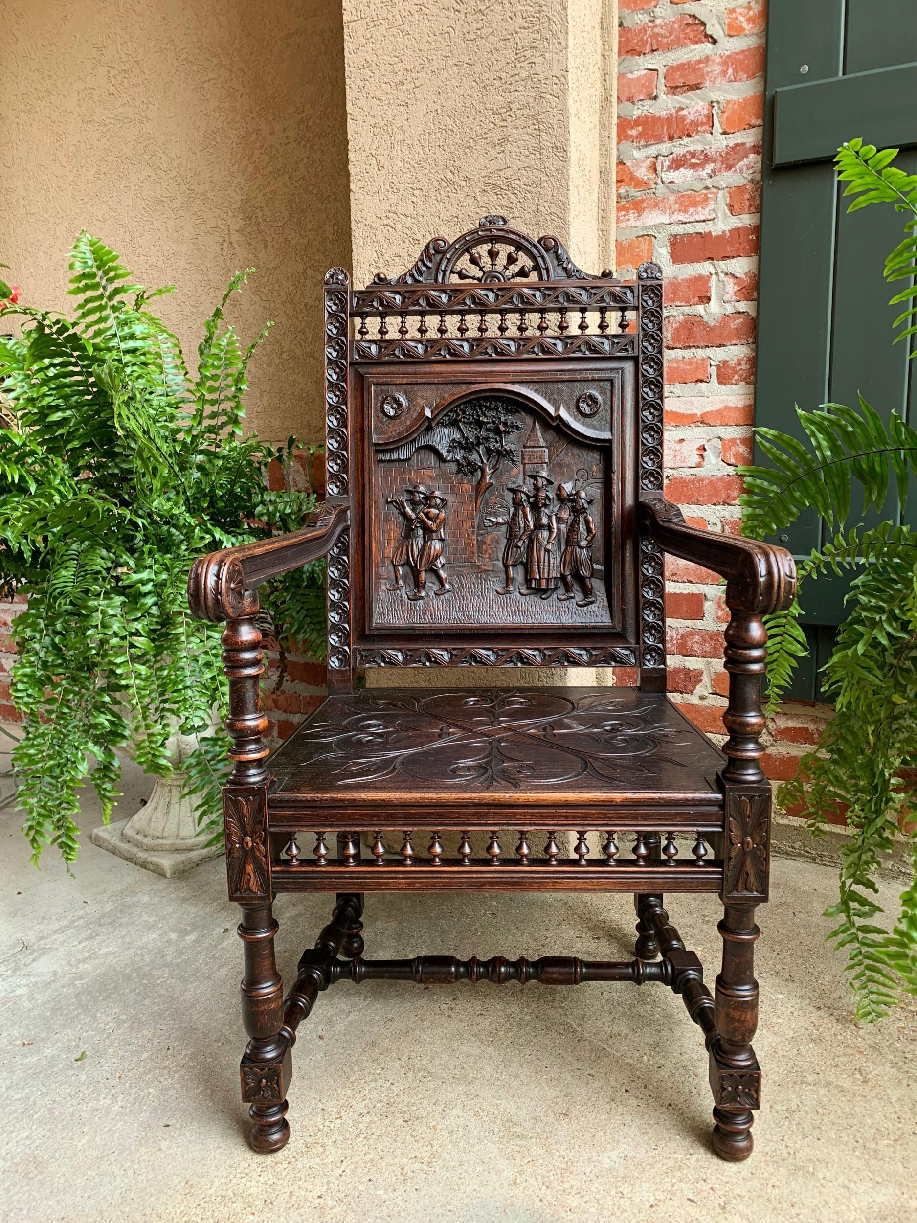 19th century French Carved Oak Arm Fireside Throne Chair Breton Brittany 

~Direct from France~
~Ornately hand carved antique French “throne” arm chair~

~Highly carved and spindled back, with upper “ship’s wheel” to the crown~
~Large detailed