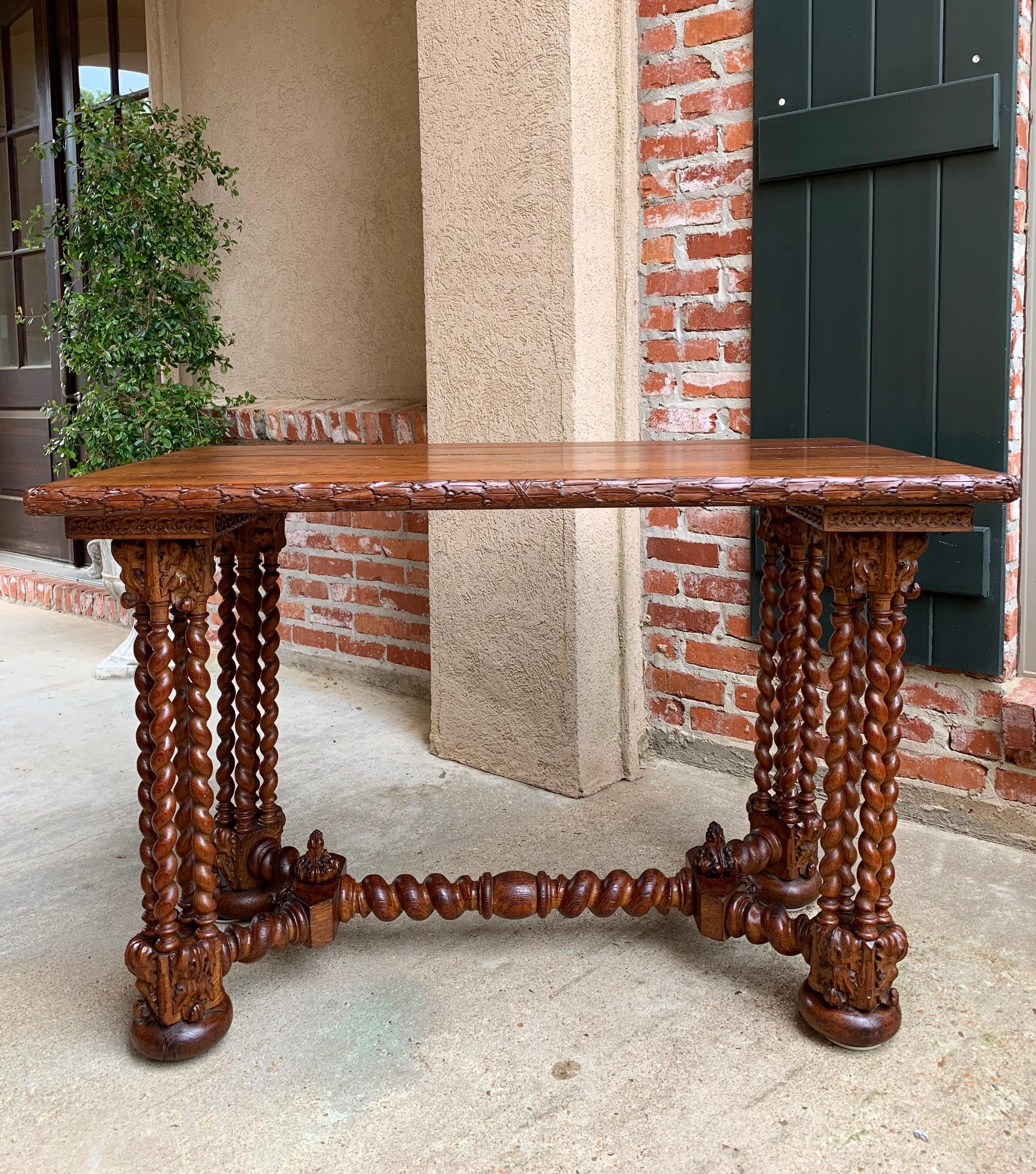 Direct from France, a very unique antique French carved oak table~
~Four large columns, each consisting of four separate barley twist posts set upon large square bases. Bases have carved trim upon all four sides and rest upon large bun feet~

~Large