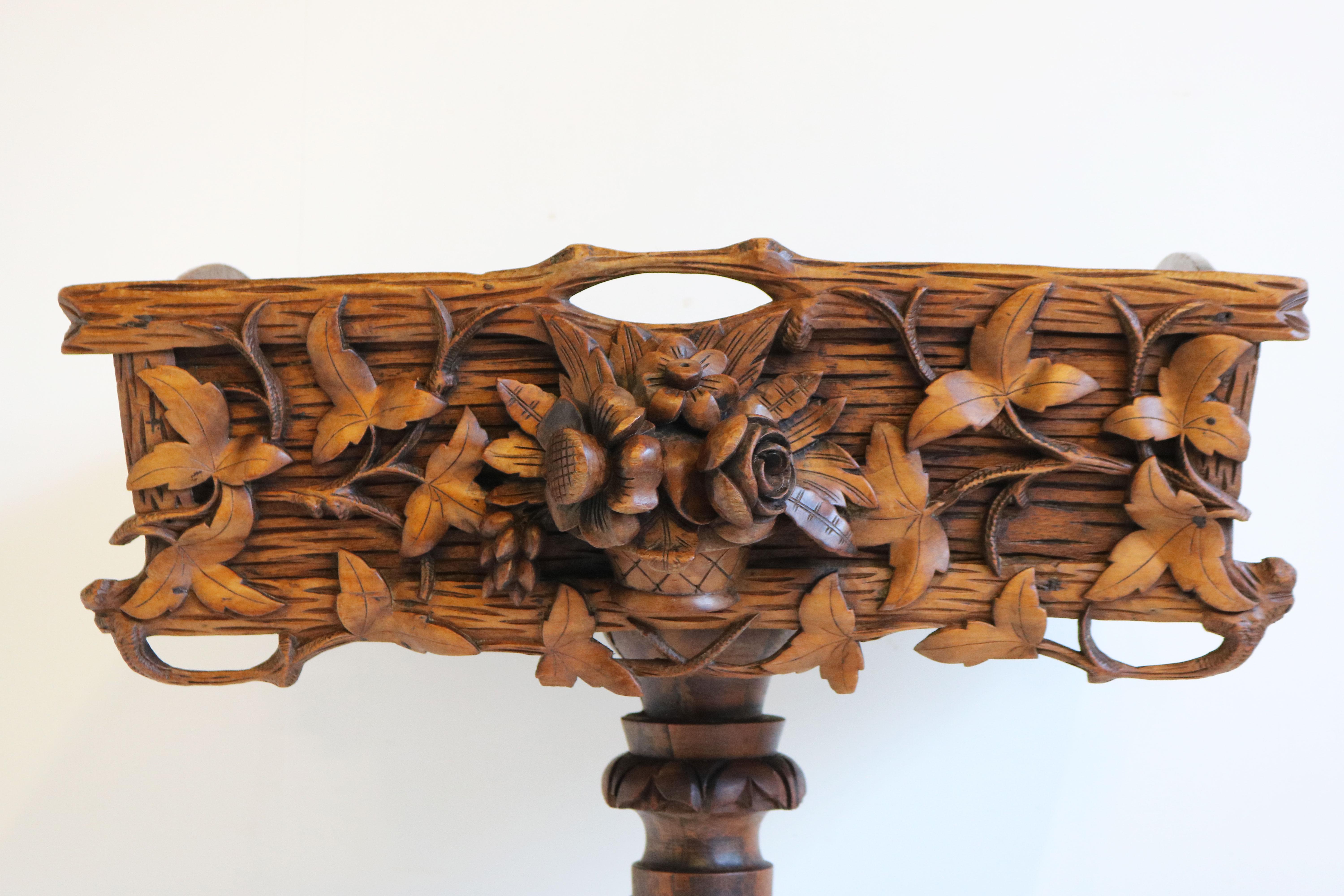 Gorgeous fully hand carved Black Forest 19th century plant stand / jardiniere in hand carved Fruitwood. 
The stand body has outstanding carvings with the center a dimensional carved bouquet of roses/flowers that extends 2” beyond the basket side.