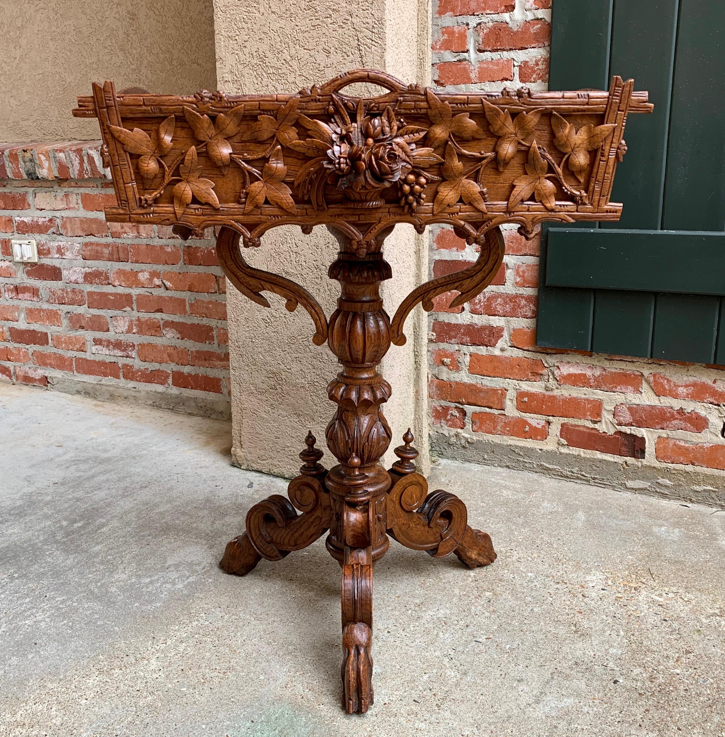 Direct from France, a lovely antique French Black Forest planter, jardinière, with exceptional carvings and details!
~ The stand body has outstanding carvings with the center a dimensional carved bouquet of roses/flowers that extends 2” beyond the