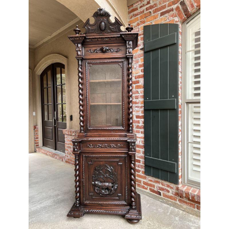 19th century French Carved Oak Bookcase Hunt Cabinet Barley Twist Black Forest Hound.

Direct from France, an exceptional 19th century, hand carved cabinet/bookcase, in a majestic 8 ft. tall, yet very slender profile.
High carved upper broken
