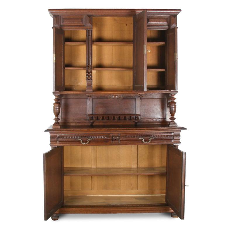 A late 19th century French carved oak ‘Henri II’ style buffet and hutch. The piece has panelled lower doors below carved gadrooned drawers, the upper section raised on columns and having three doors, the middle one carved with a hunter on