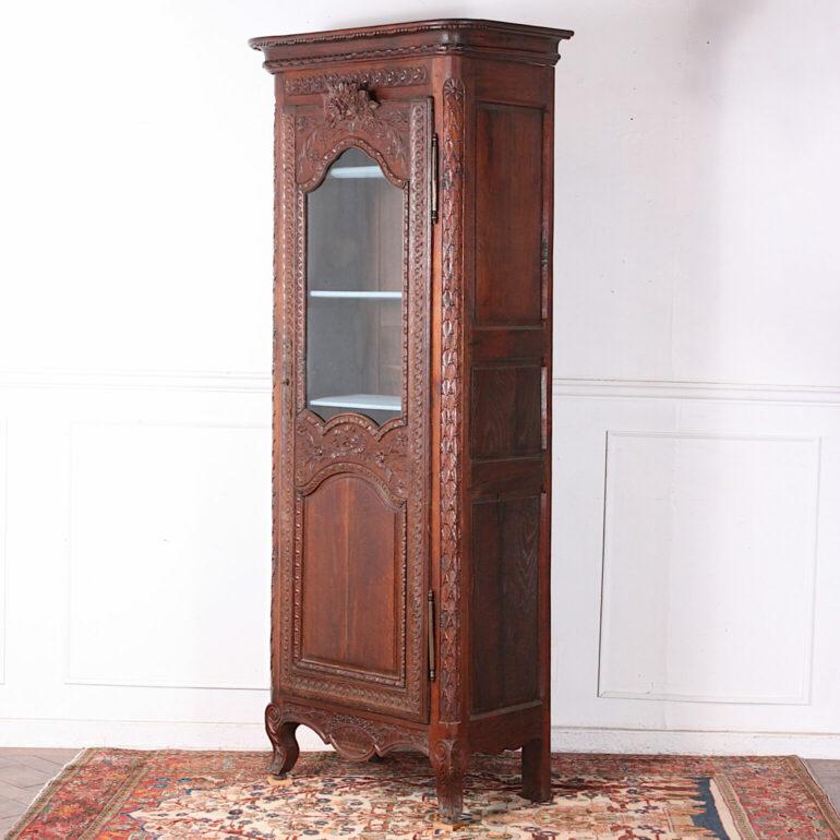 Carved oak French single door cabinet or vitrine, profusely carved with flowers and ribbons etc. C. 1880.


