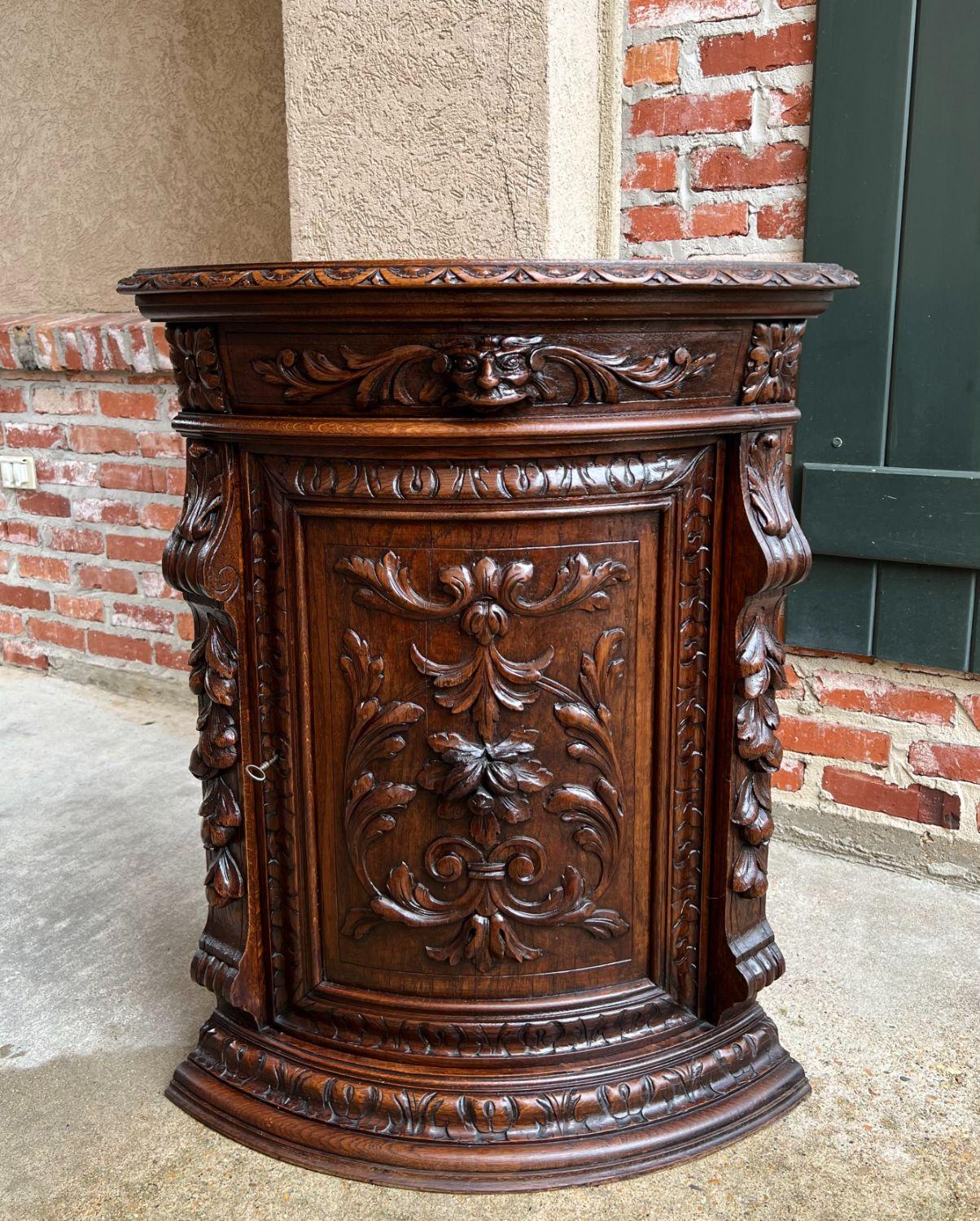 19th century French carved oak corner cabinet renaissance petite arched front.

Direct from France, a beautifully hand carved corner cabinet, in a petite size, perfect for placement in so many areas (very suitable for a vanity sink)!
Carved beveled