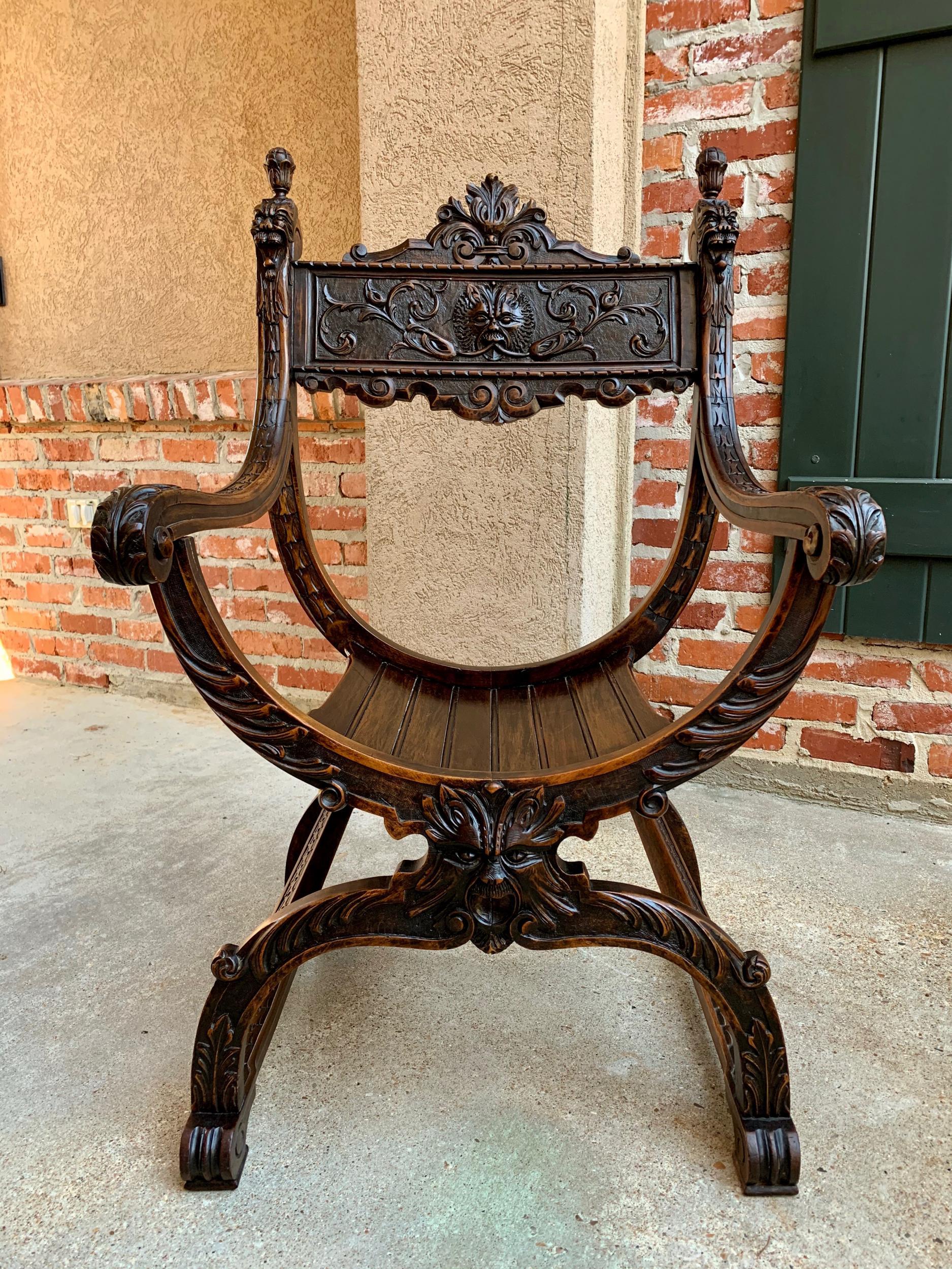 19th century French carved oak curule chair arm throne Renaissance Dagobert

~Direct from France~
~Stunning antique carved oak curule chair with beautifully detailed hand carvings from top to bottom.~
~Large ornate back panel features a high carved