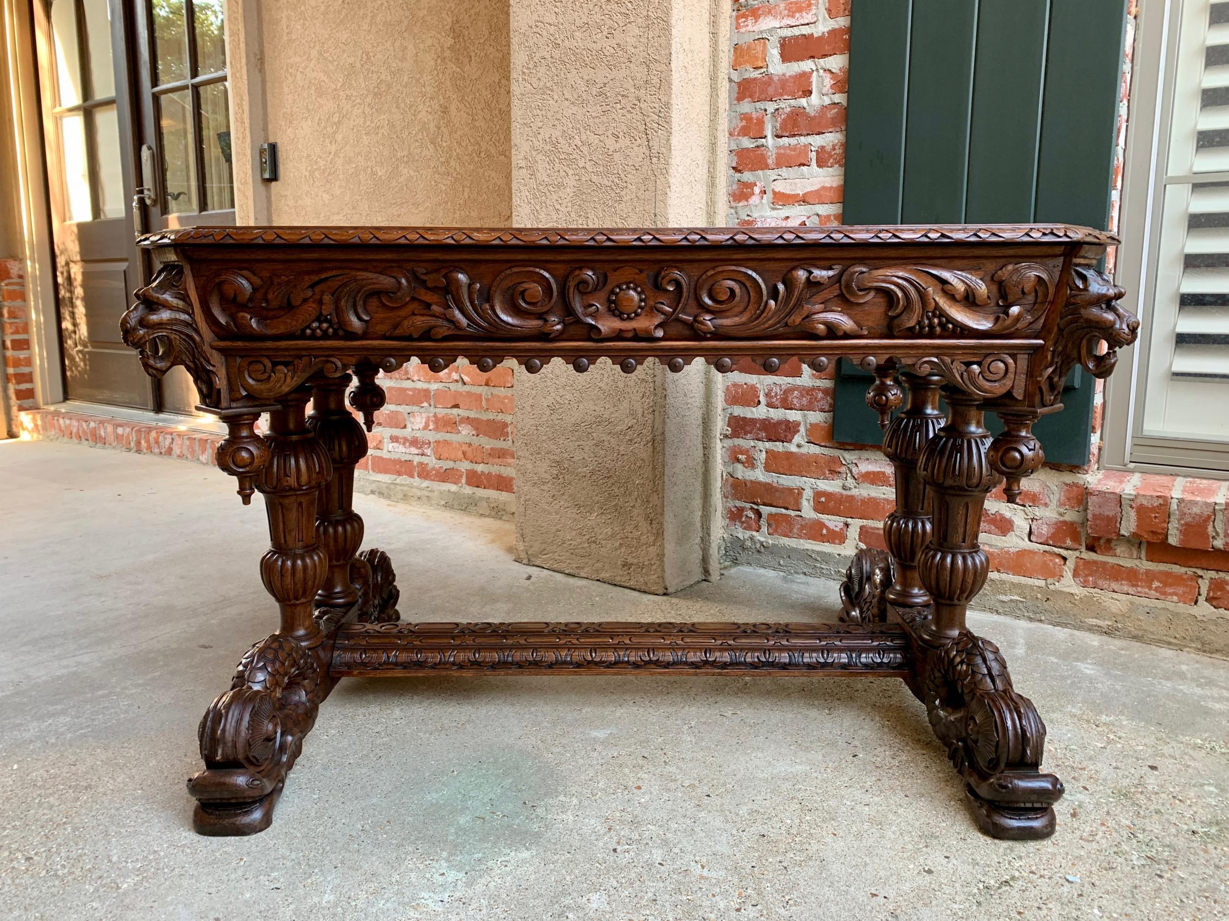 19th century French carved oak desk sofa side table dolphin Renaissance Gothic

~Direct from France~
~An elegant antique French carved oak library table or “bureau plat” desk, commonly referred to as a ‘dolphin’ table, so called for the ornately