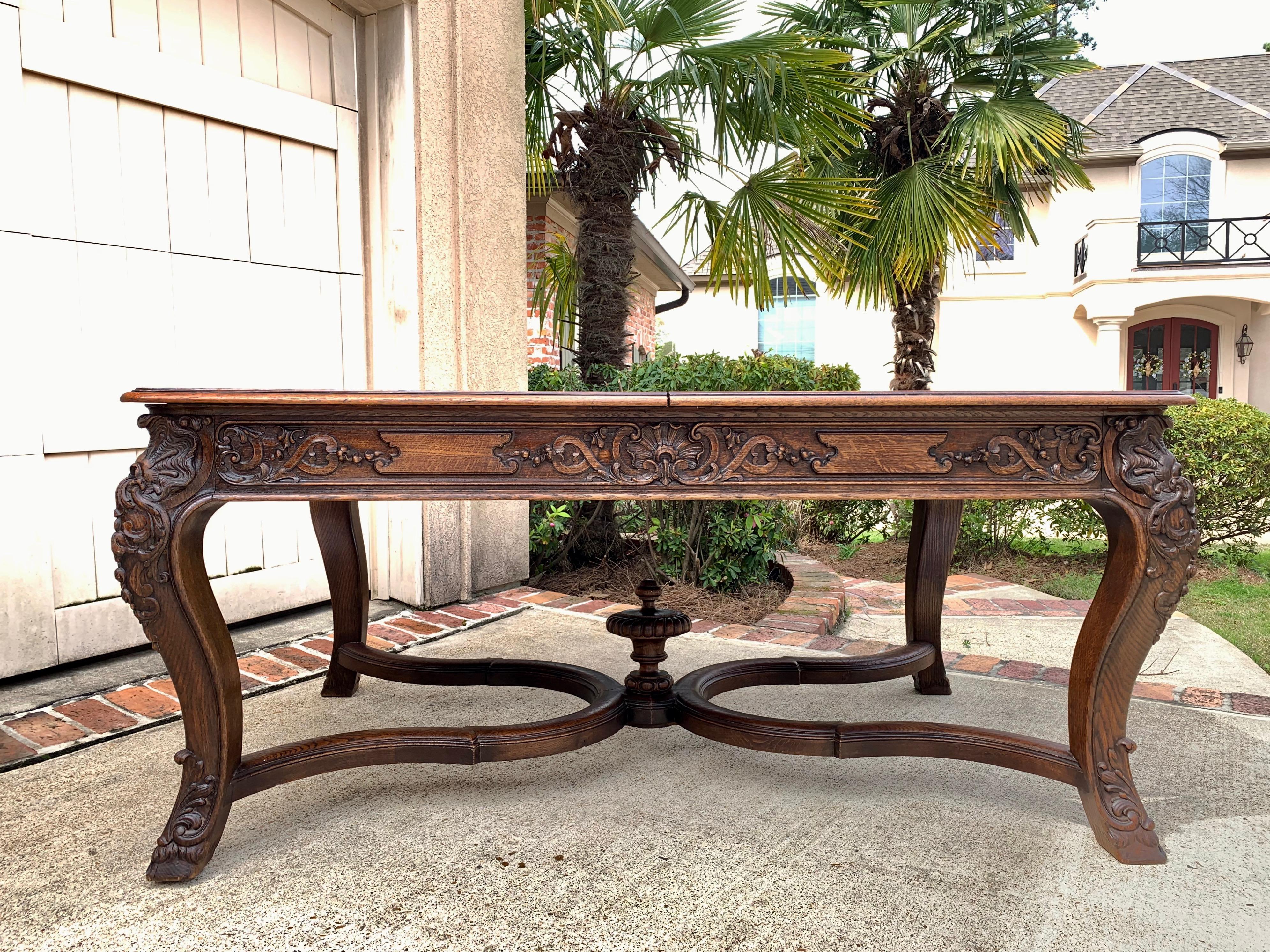 Direct from France, a heavy and substantial antique French carved dining table!~
~Stunning hand carved details, definitely above average quality, as you can tell with one glance to the massive carvings. The table legs have dimensional French shells