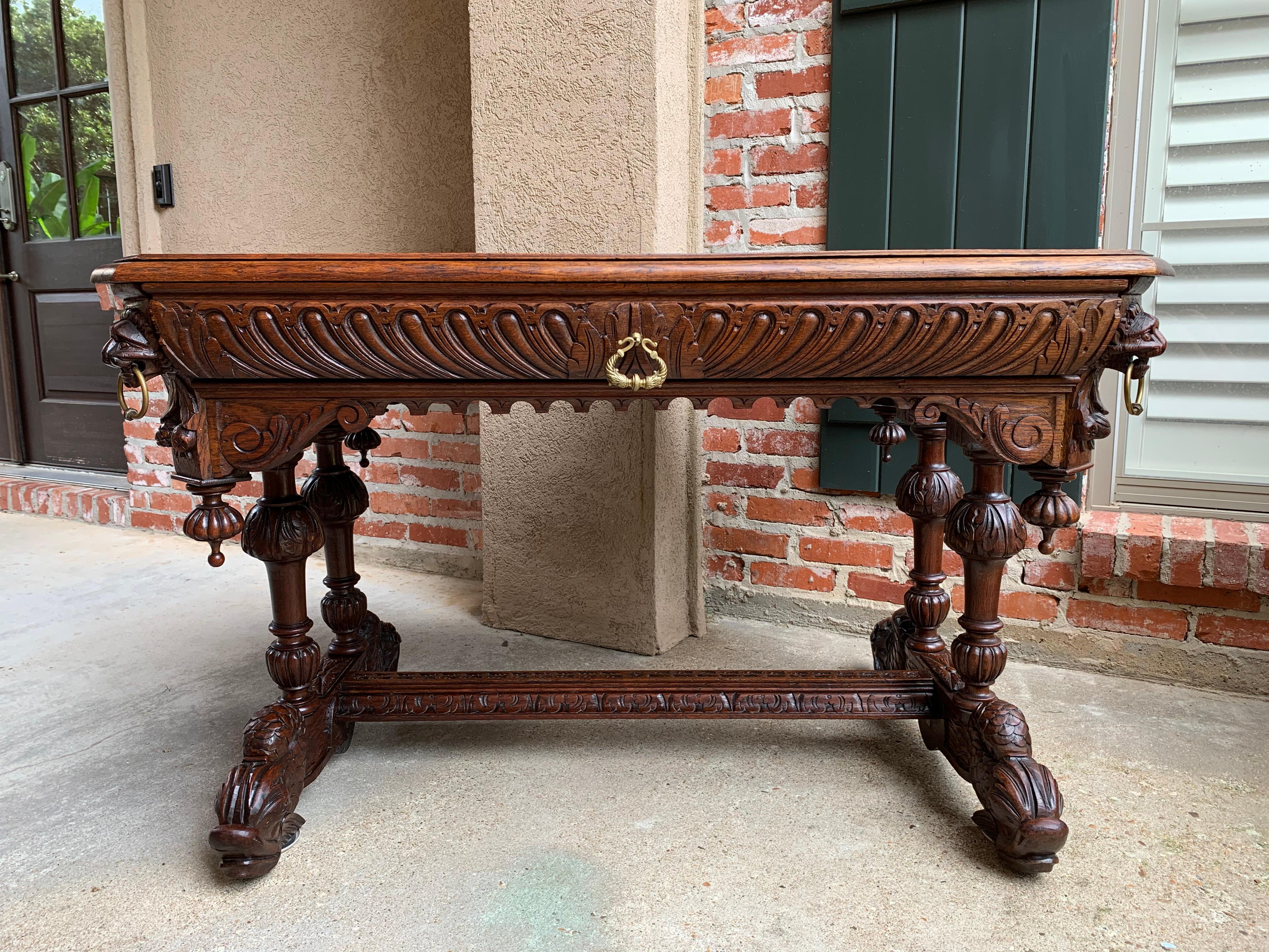 ~Direct from France~
~A wonderful antique French carved oak library tale or “bureau plat” desk, commonly referred to as a ‘dolphin’ table, so called for the ornately carved “dolphin” feet!~
~Very large size for this style, making it perfect for a