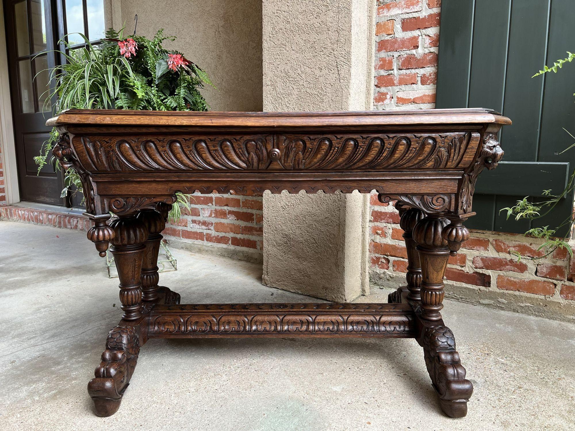 19th century French carved oak Dolphin library table desk Renaissance Gothic.
 
Direct from France, an elegant antique French carved library table or 