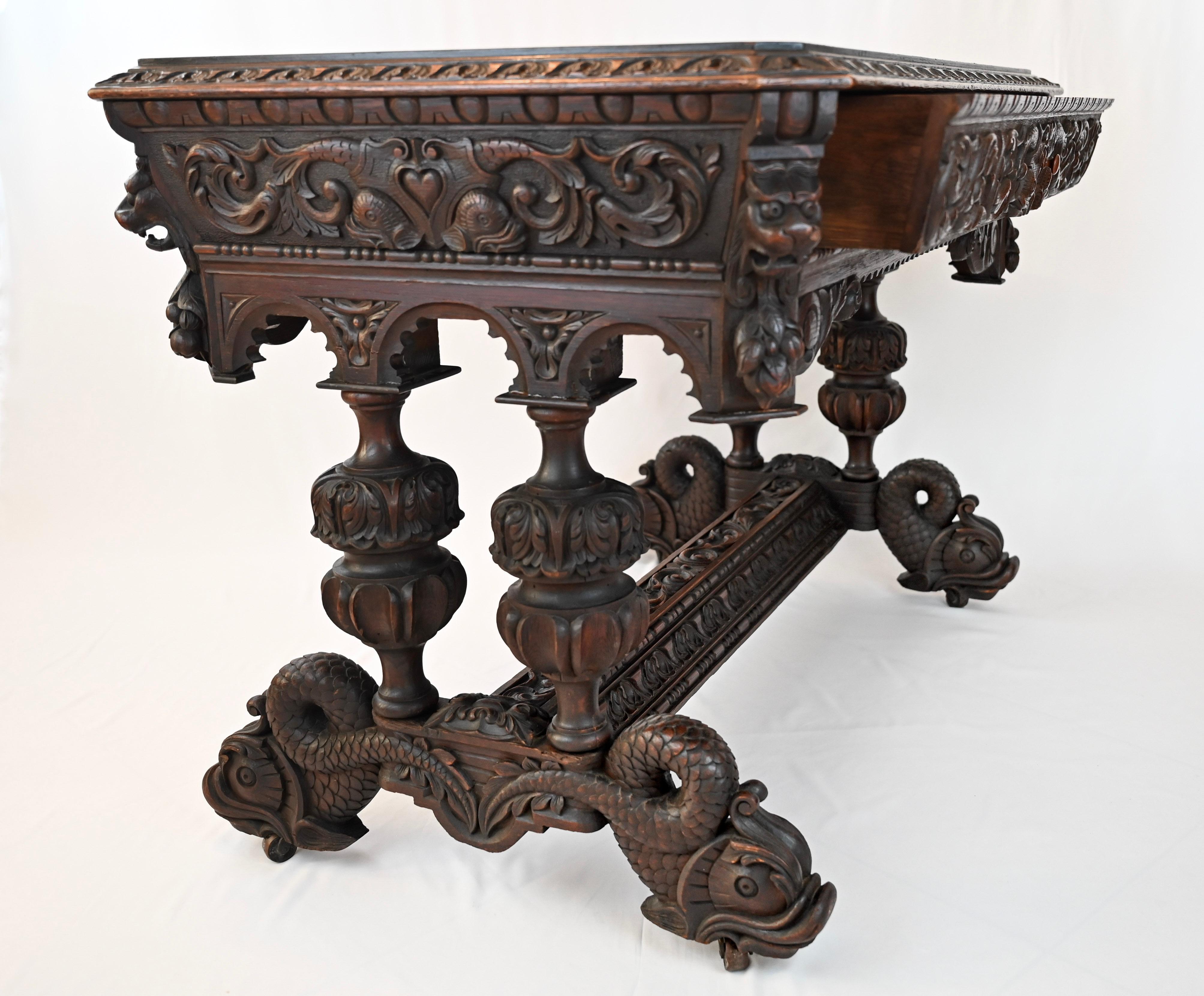 A stunning 19th century French carved oak Dolphin library table desk Renaissance Gothic style. 

Direct from France, an elegant antique French carved library table or writing desk, commonly referred to as a “dolphin