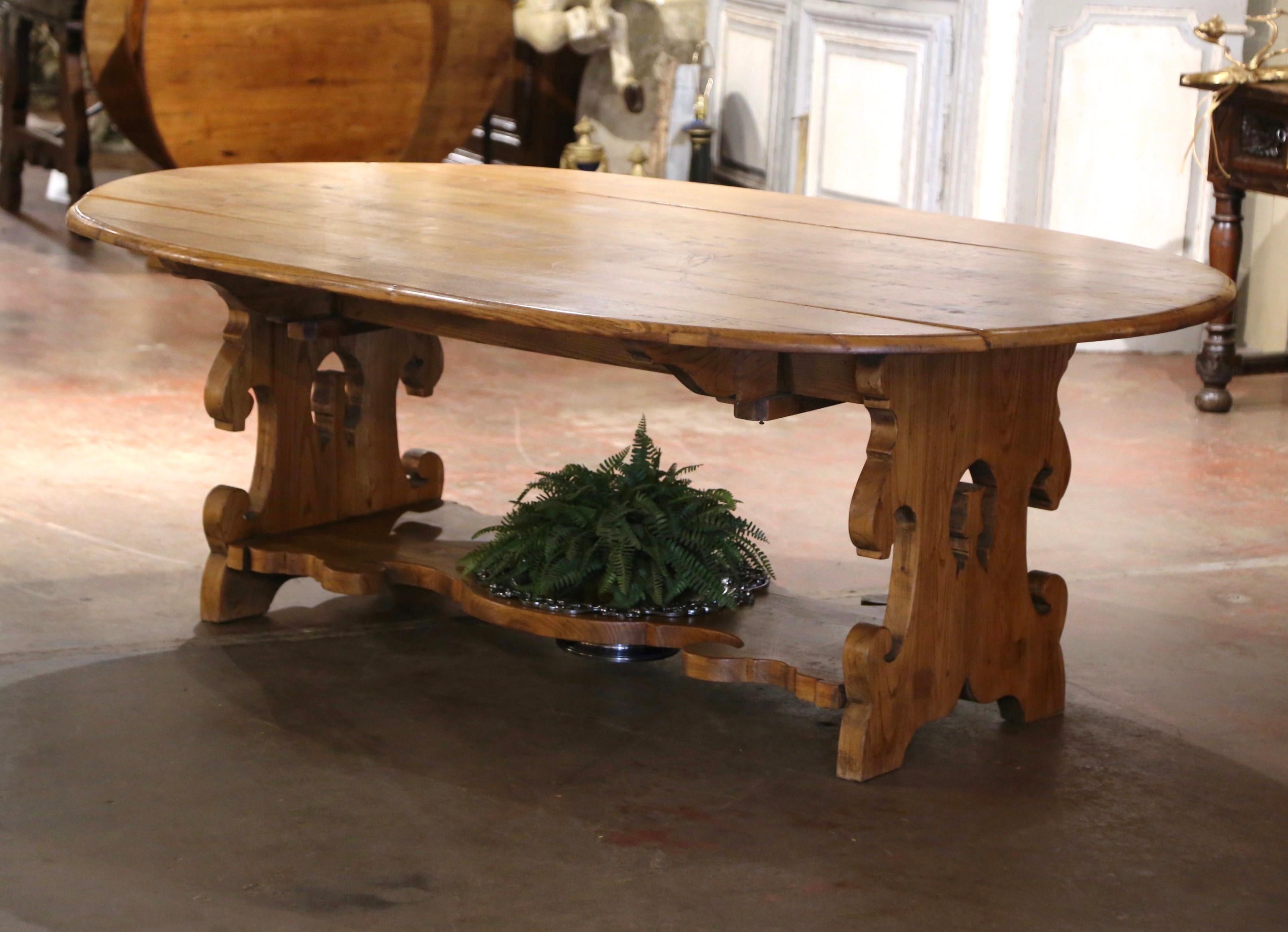 Decorate a breakfast room or dining room with this elegant antique table. Crafted in France circa 1850 and oval in shape, the large fruitwood table built from solid oak wood, stands on curved and carved legs, and embellished with a decorative