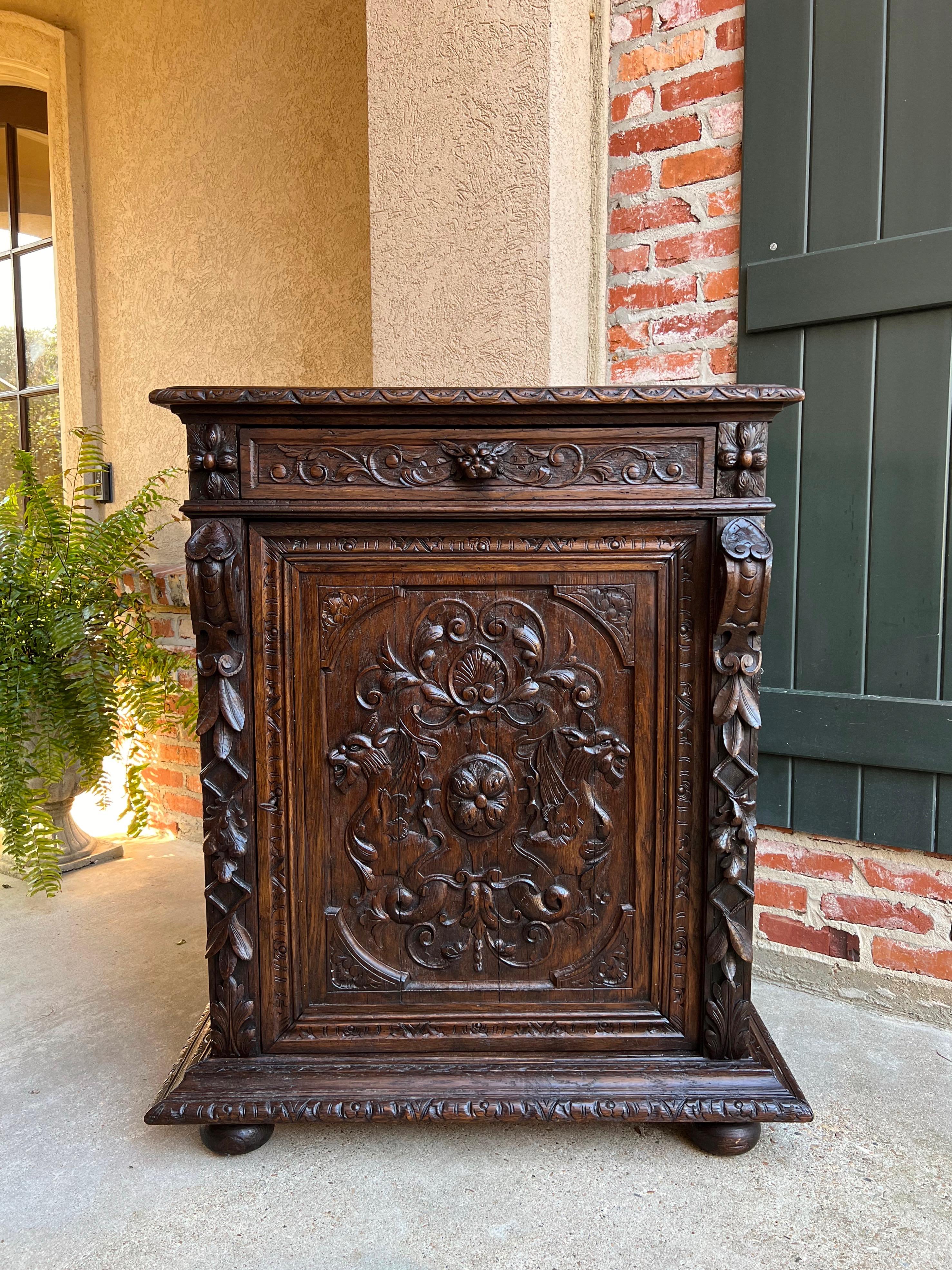 19th century French carved oak hunt cabinet confiturier renaissance 

Directly imported from France, a beautifully hand carved 19th century French confiturier cabinet.
Carved beveled edge cabinet top over the carved frieze that features a full