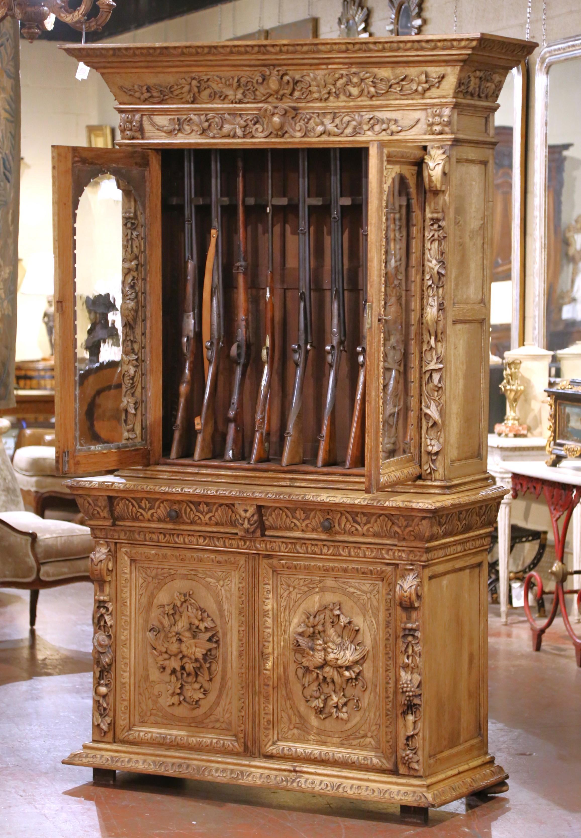 Bleached 19th Century French Carved Oak Nine-Gun Cabinet with Bird and hunt Motifs For Sale