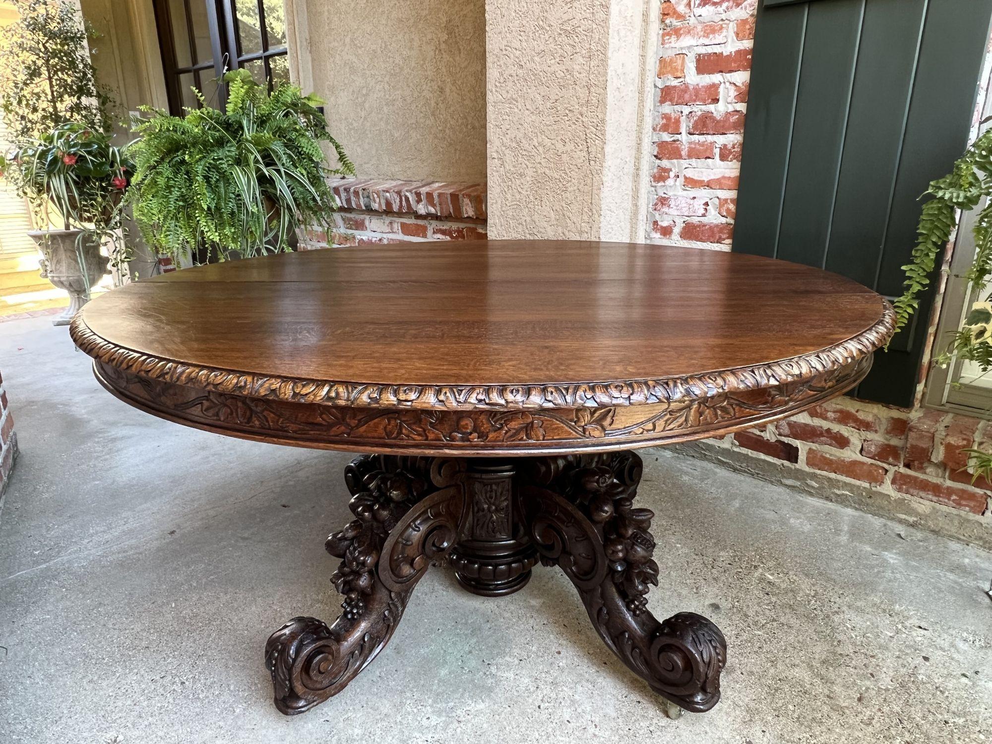 19th century French carved oak oval dining table black forest game library table.
 
Direct from France, a large and substantial 19th century hand carved oval table!
 
Huge base is a work of art! Elaborate hand carvings on the baluster and the